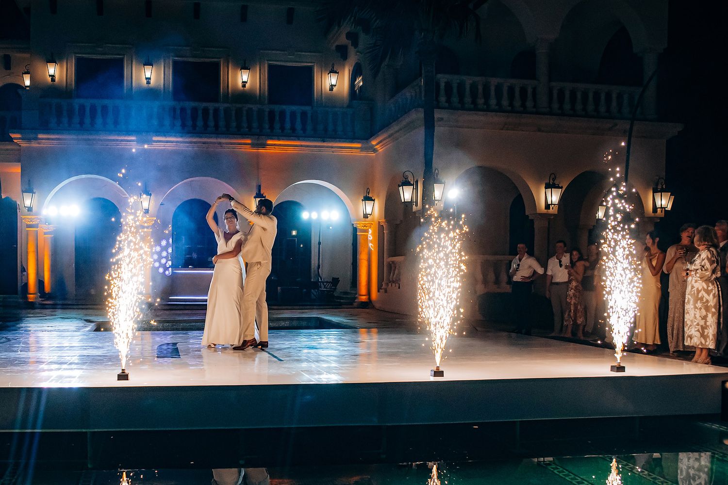 Wedding celebration with dramatic sparkler fountains lighting up the night.