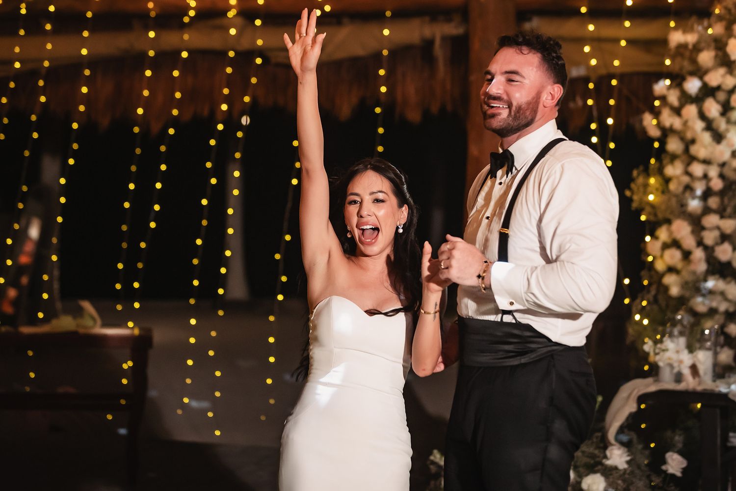 A joyful dance celebration moment under twinkling barn lights and disco balls.
