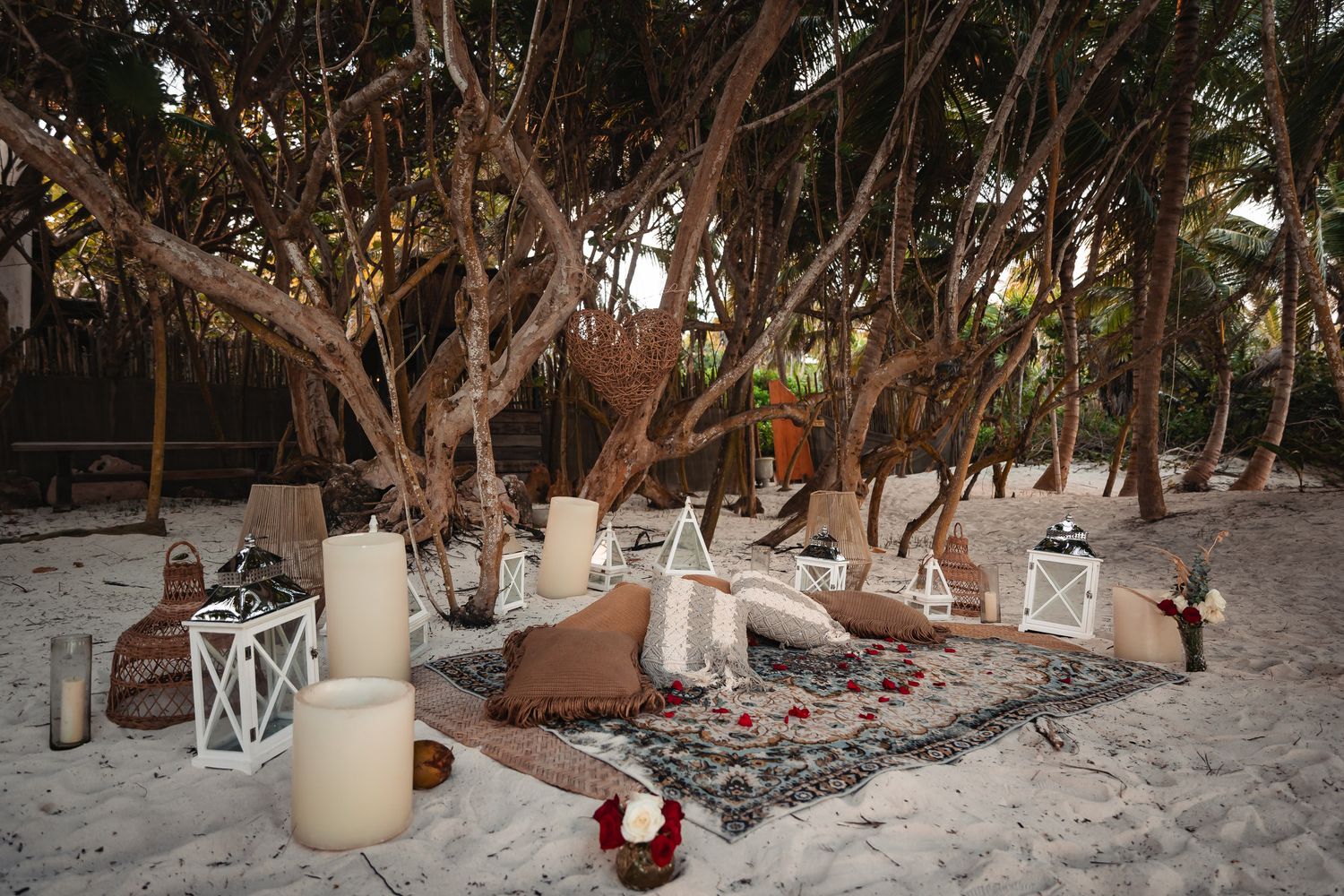 Sandy beach path lined with palm trees and decorative lighting elements.