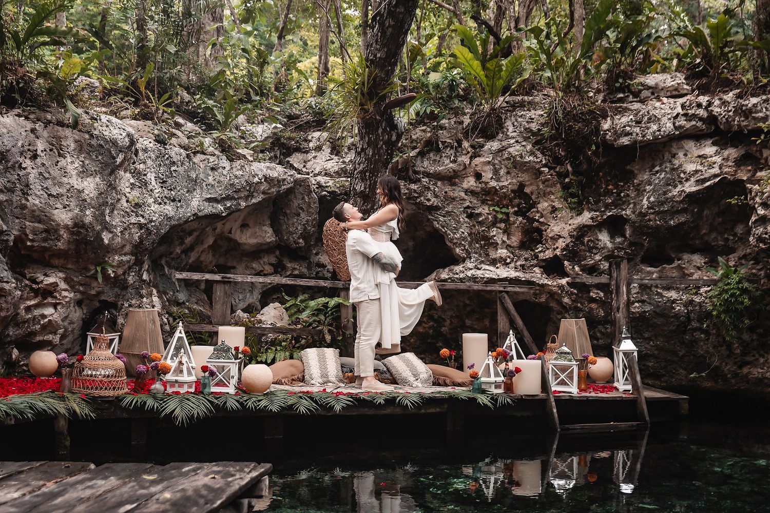 Romantic scene on wooden platform by turquoise water against limestone cliffs.