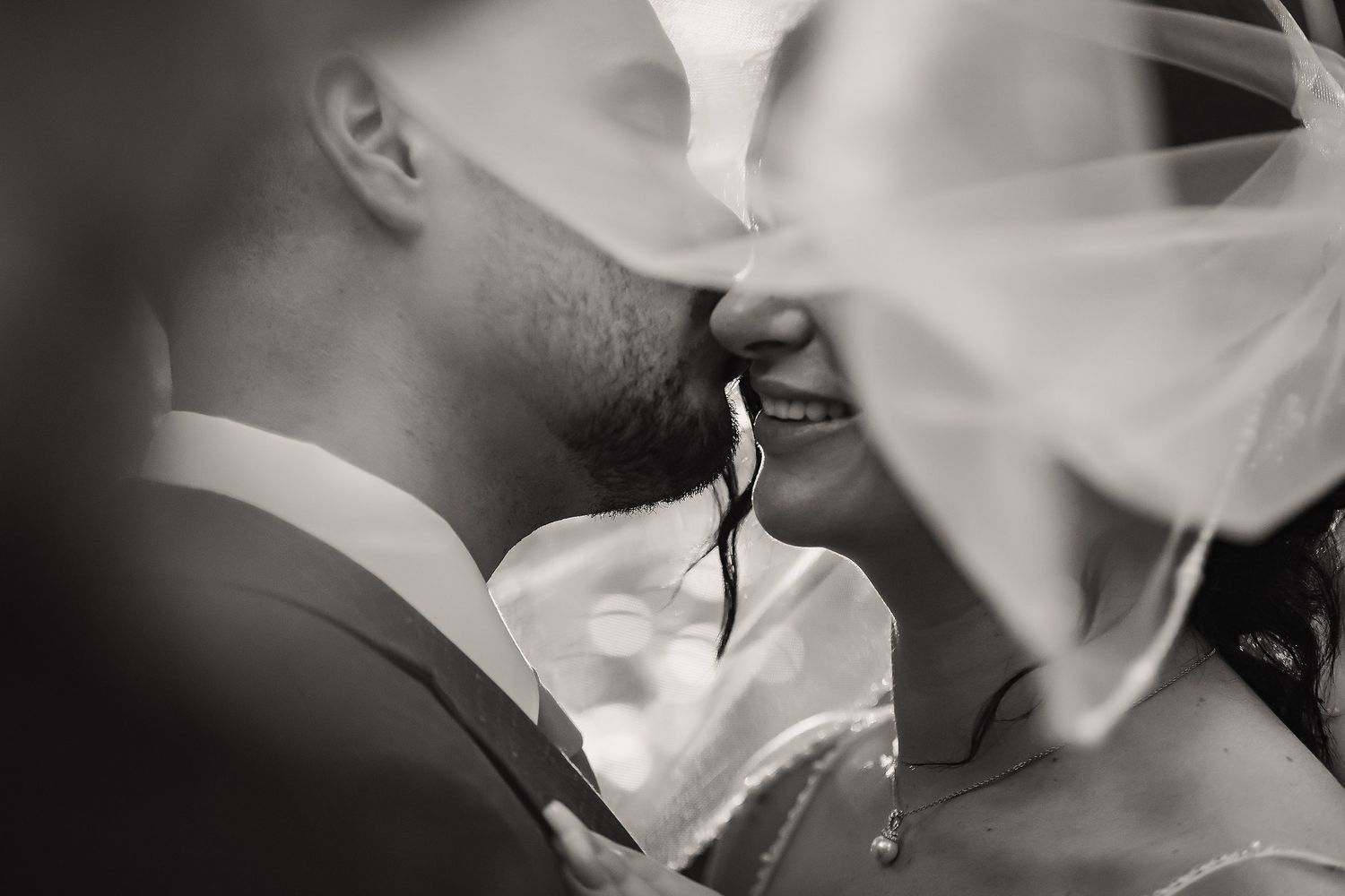 Artistic black and white close-up of wedding veil details.