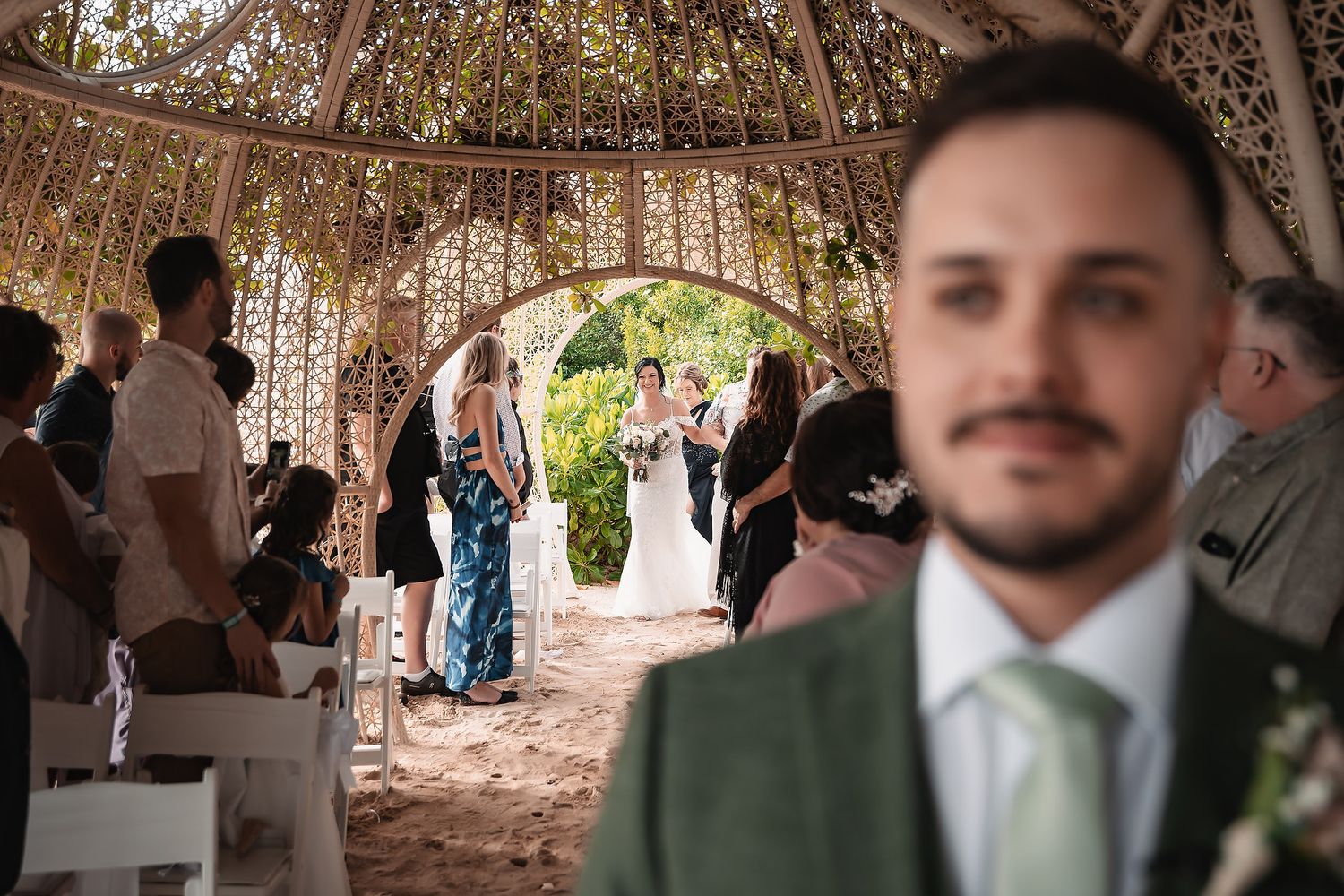 Wedding venue decorated with woven dome structures creating intimate gathering spaces.