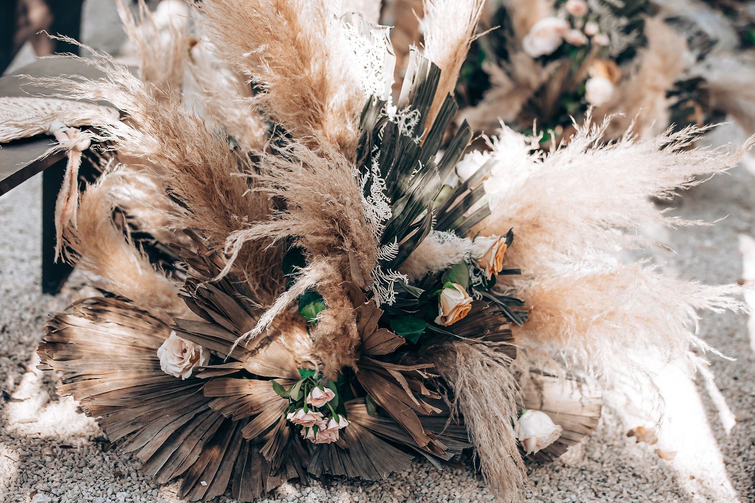 Close-up macro photograph of delicate pink and white dried flowers with textural details and soft lighting.