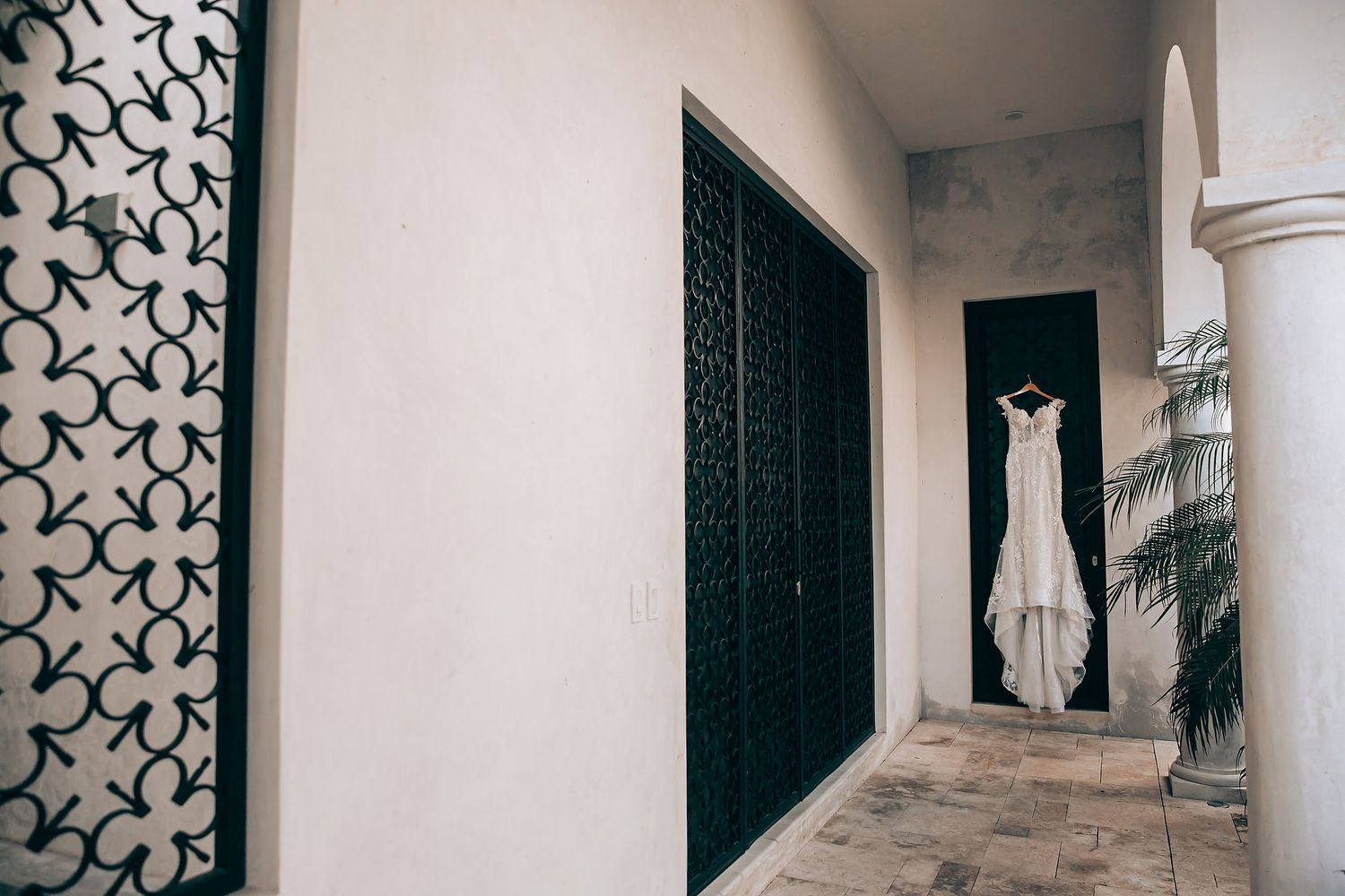 Modern interior hallway with geometric pattern wall panels, white walls, and decorative architectural details.