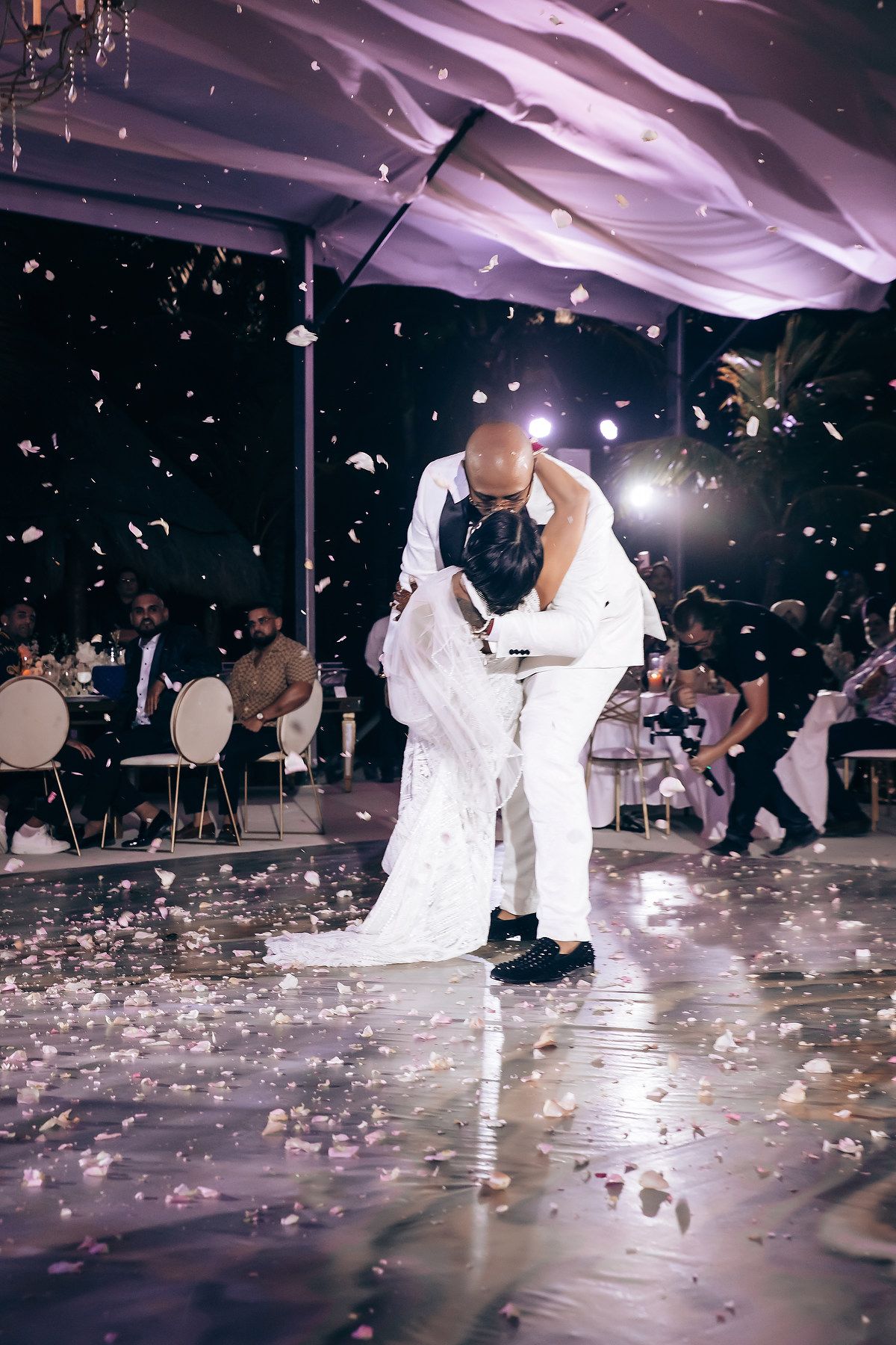 Wedding reception dance floor with confetti and dramatic lighting.