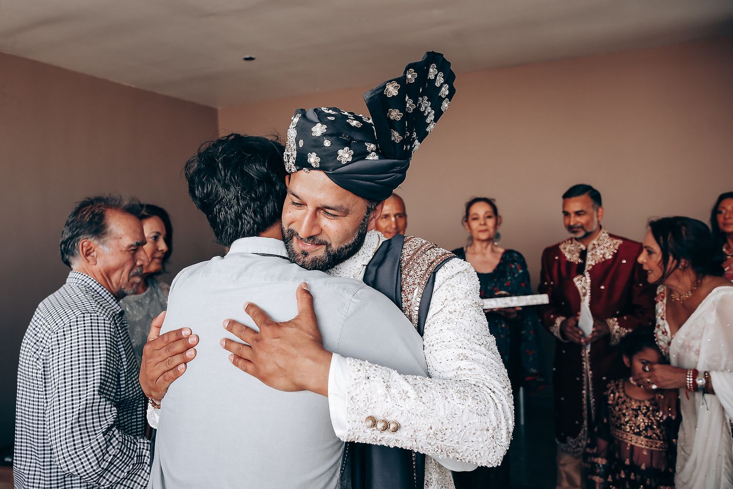 A series of candid photos showing people hugging and embracing during what appears to be a social gathering or celebration.