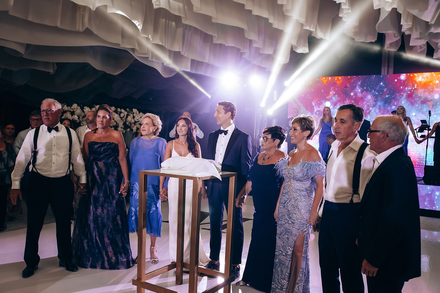 Wedding speech being delivered at an elegant reception with formal attire and decor.