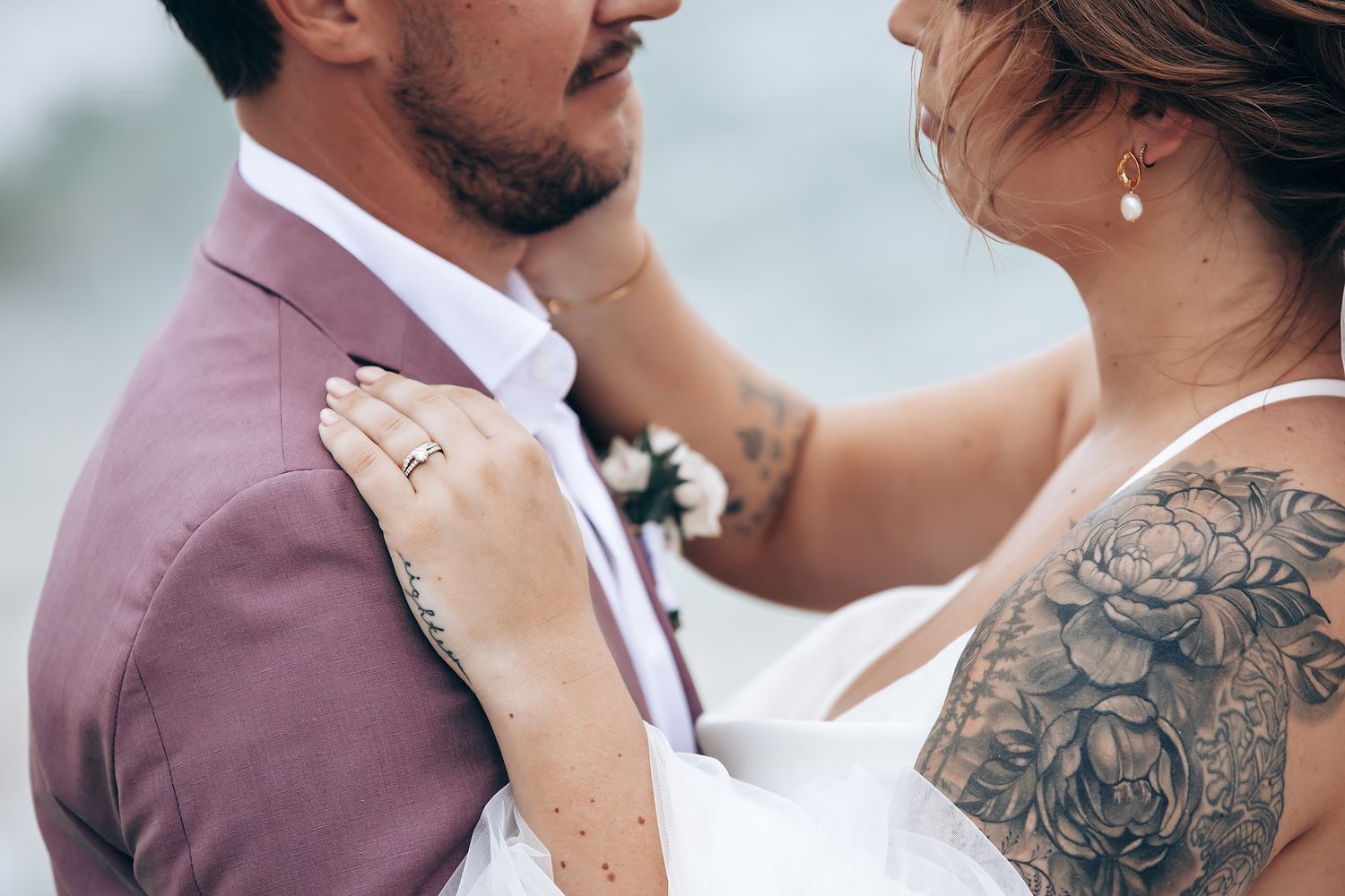 Close-up wedding portraits showing intimate moments between newlyweds with visible tattoo details.