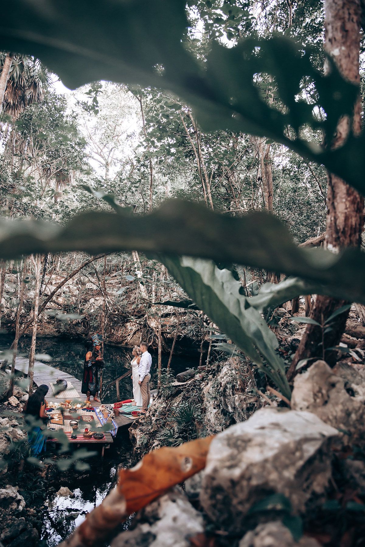 Outdoor wedding ceremony setup in a natural forest setting with trees creating a romantic woodland atmosphere.