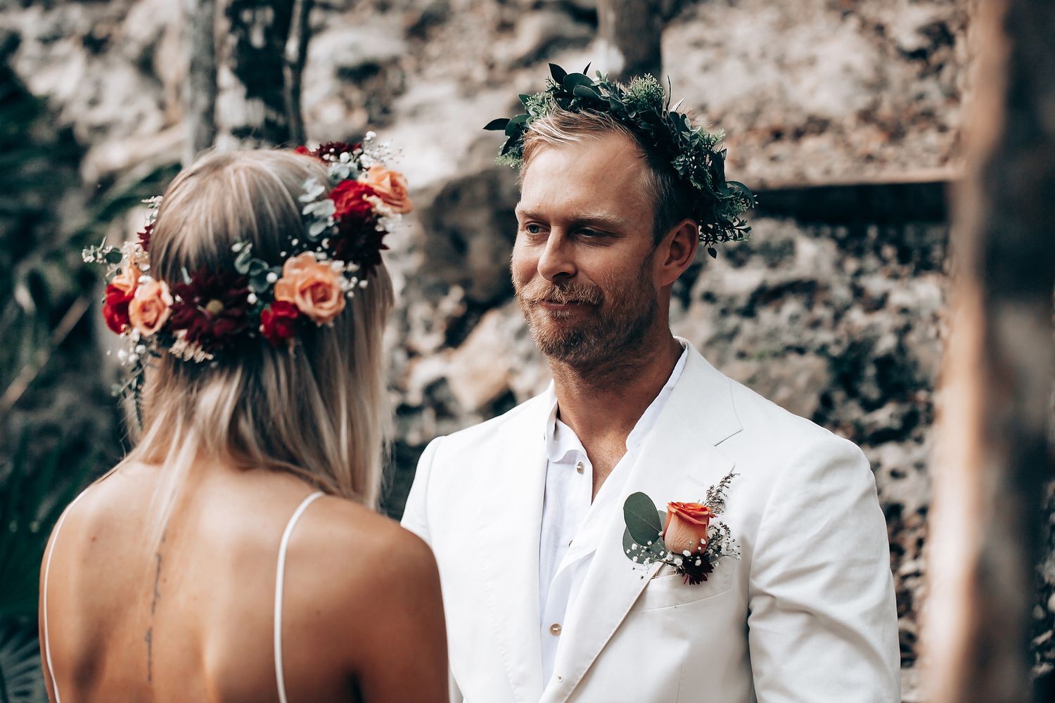 Intimate wedding ceremony moments captured in a natural forest setting with floral details.
