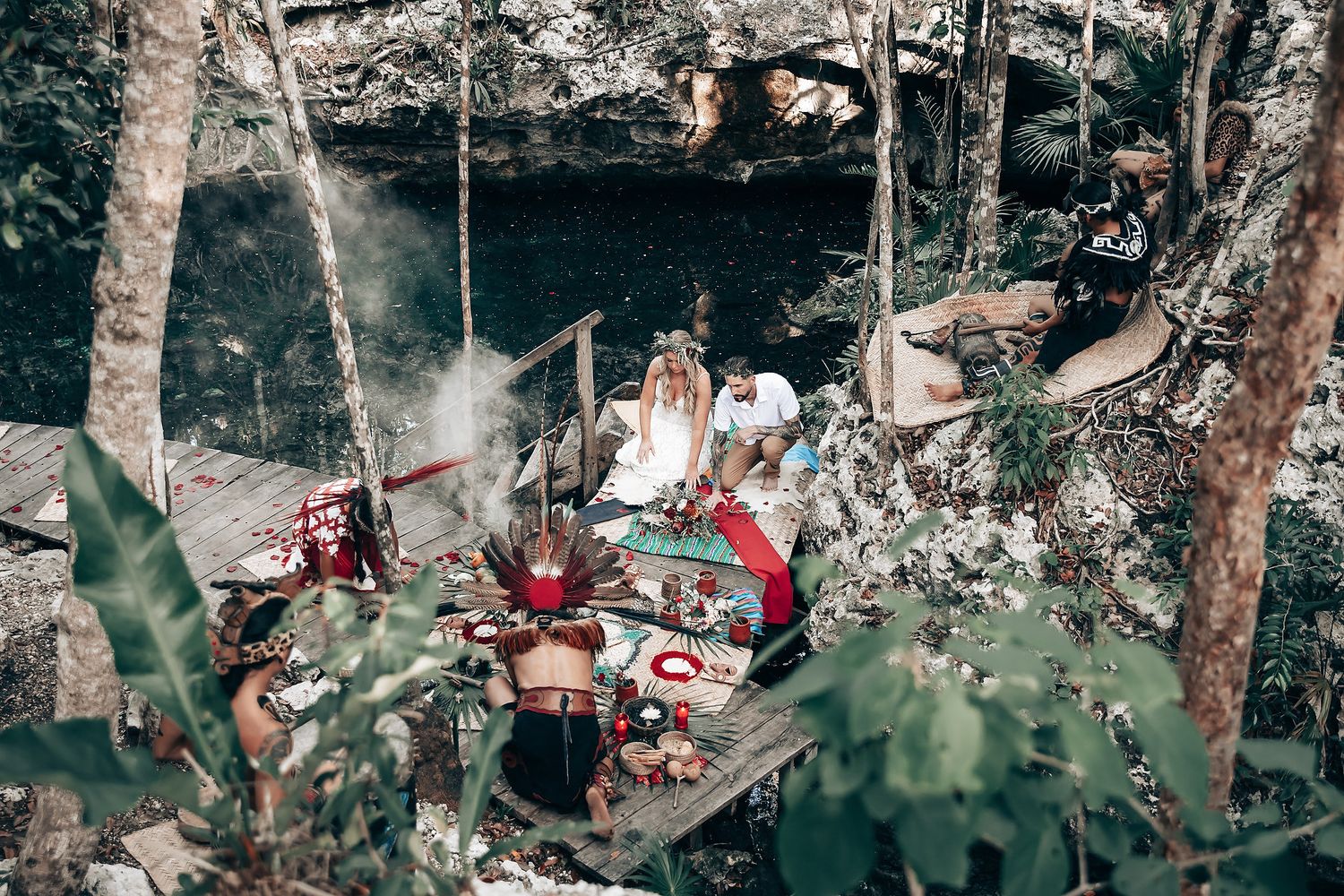 Outdoor forest gathering with decorative elements visible through trees.