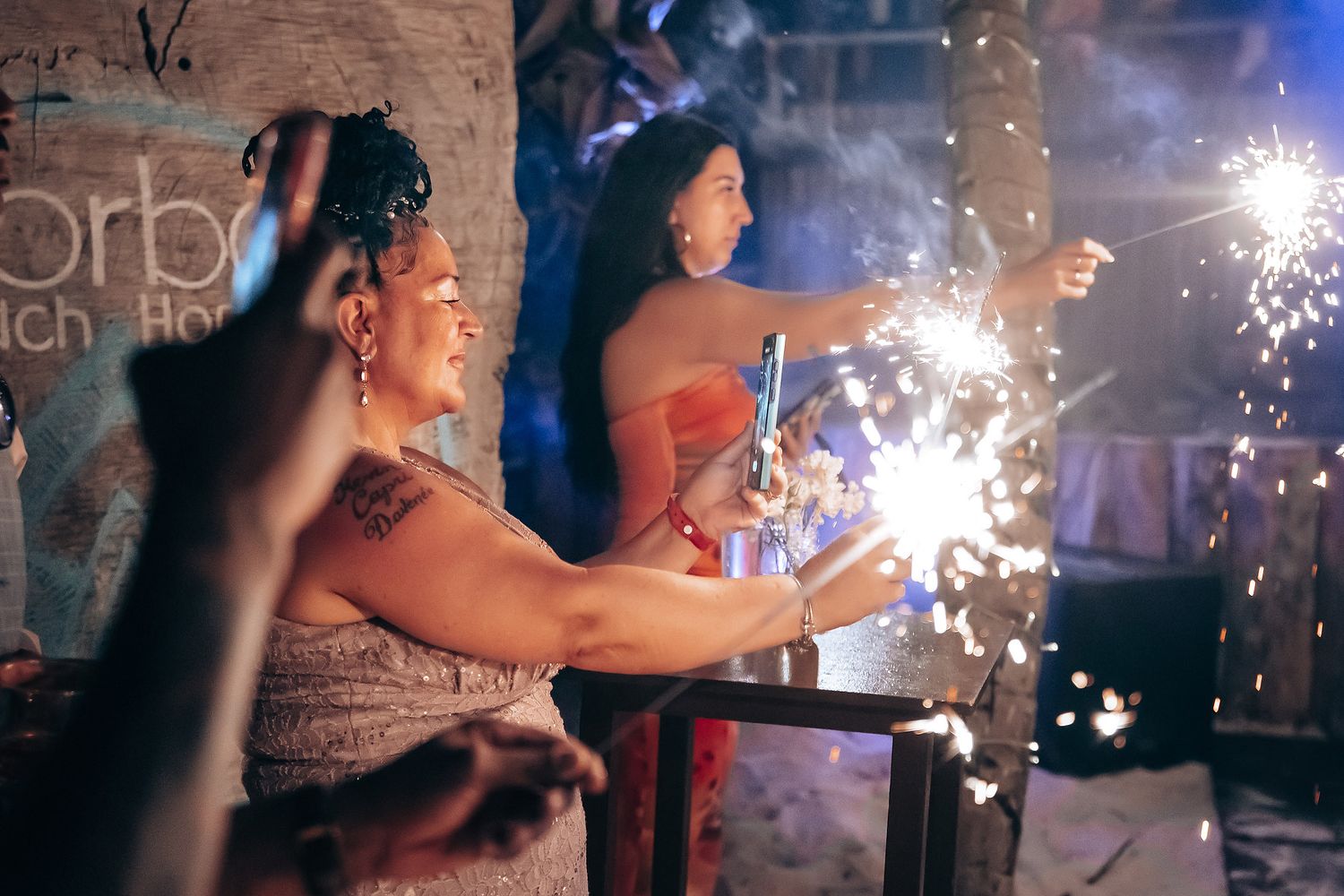 Wedding celebration with sparklers creating magical light trails in the dark.