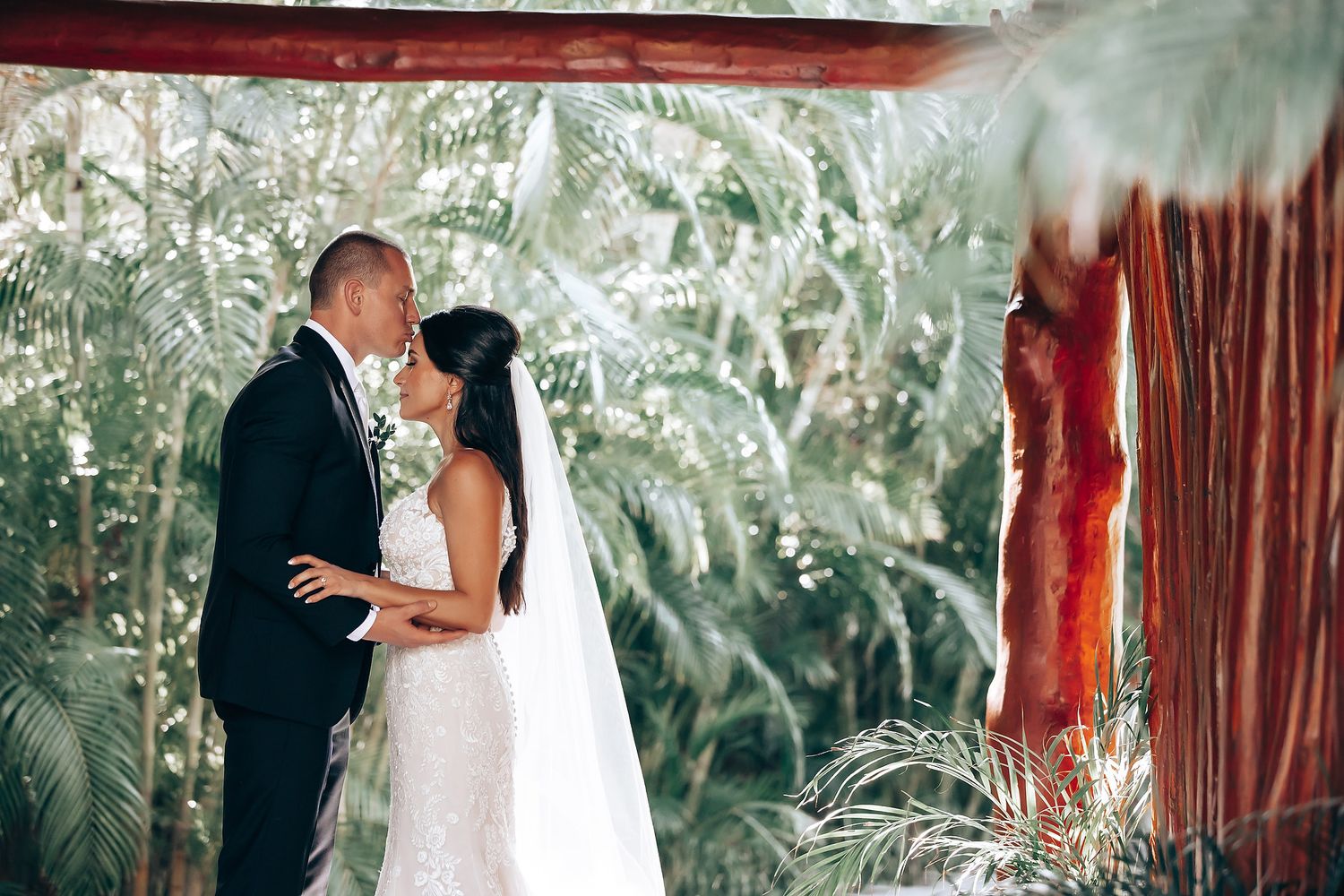 Newlyweds sharing intimate moments during their beach wedding photo session.