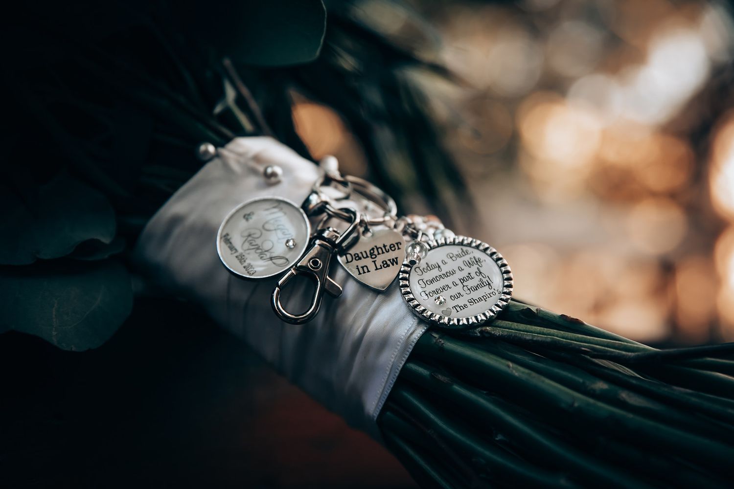 Close-up details of elegant wedding rings and jewelry on dark background.