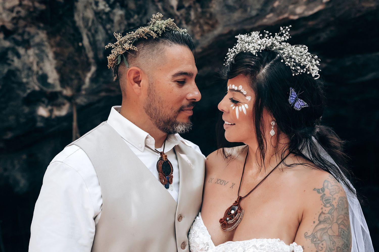 A tender moment captured between a couple in formal attire during their cave photoshoot.