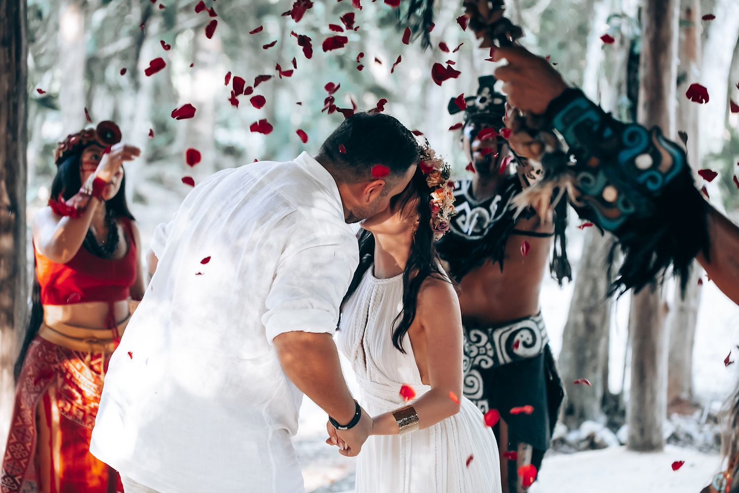 Rose petals falling during an intimate forest wedding celebration.