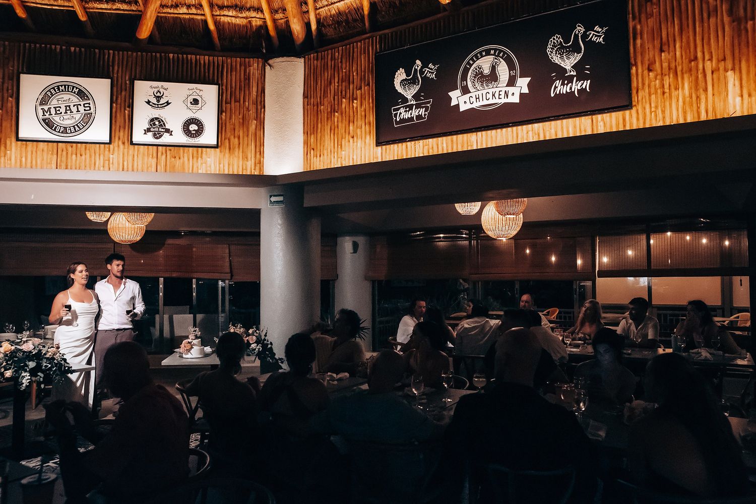 Rustic wooden reception venue decorated with string lights and nautical decor.
