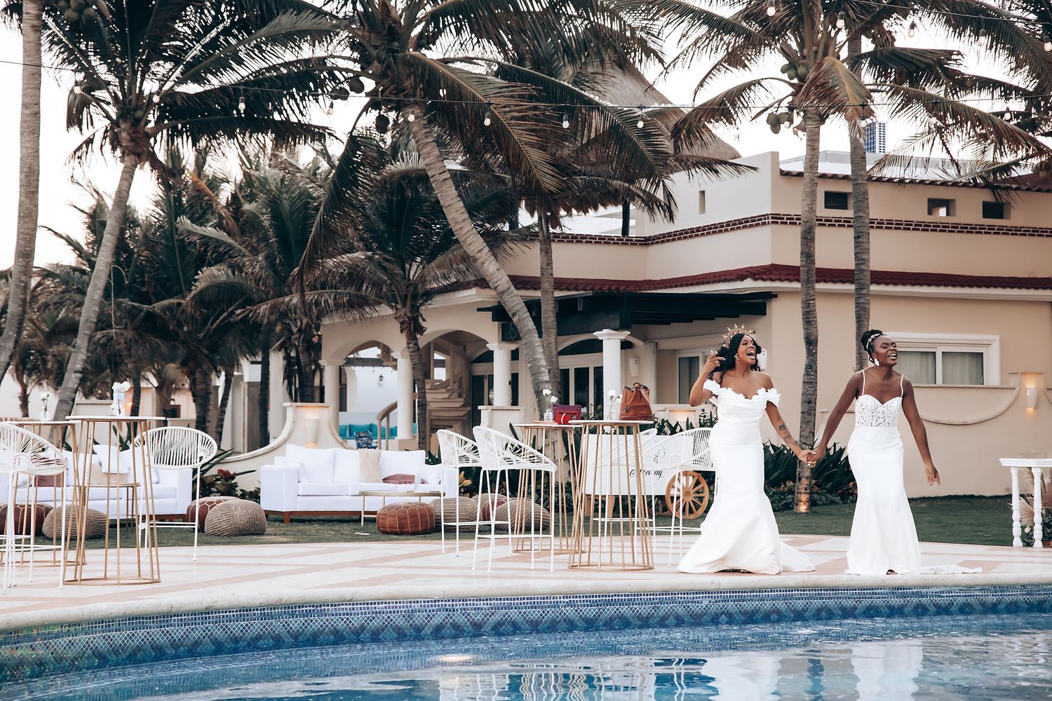 Poolside wedding reception setup with palm trees and tropical resort backdrop.