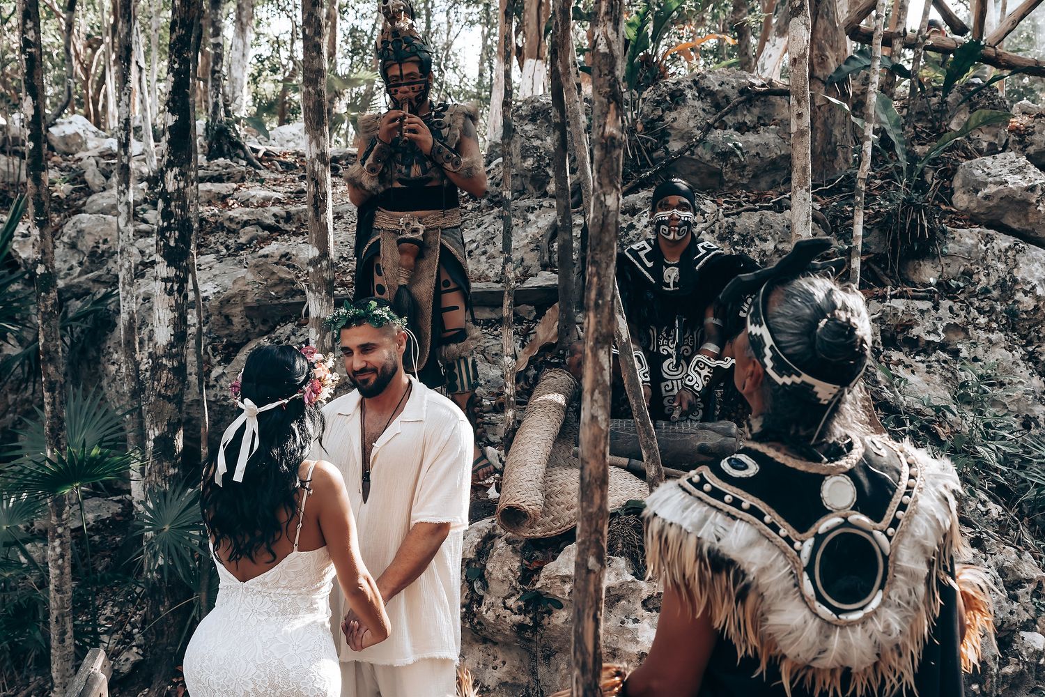 A couple embraces in a rustic forest setting during a romantic outdoor photoshoot.