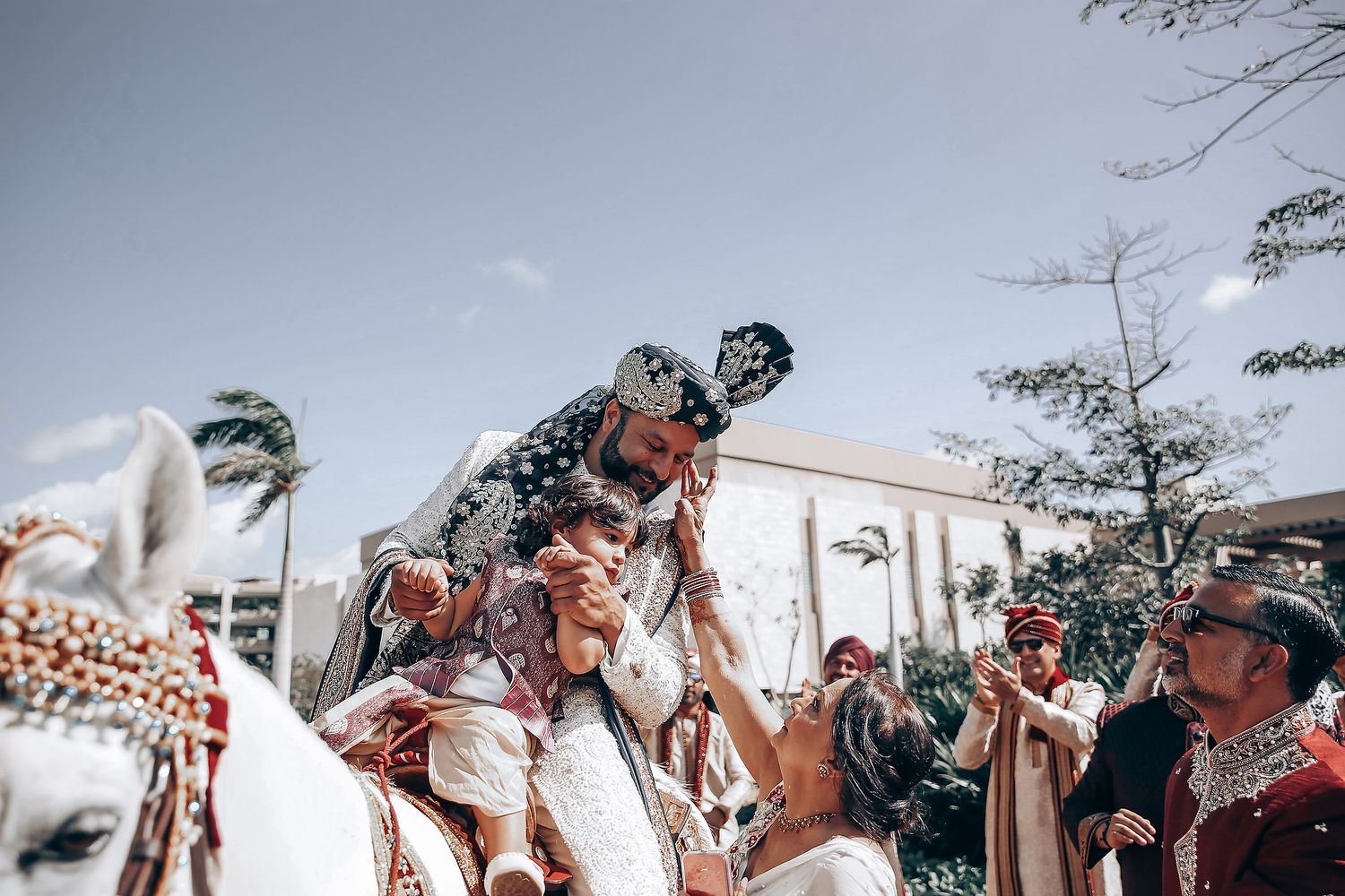 Outdoor celebration with guests raising hands in joyful celebration.
