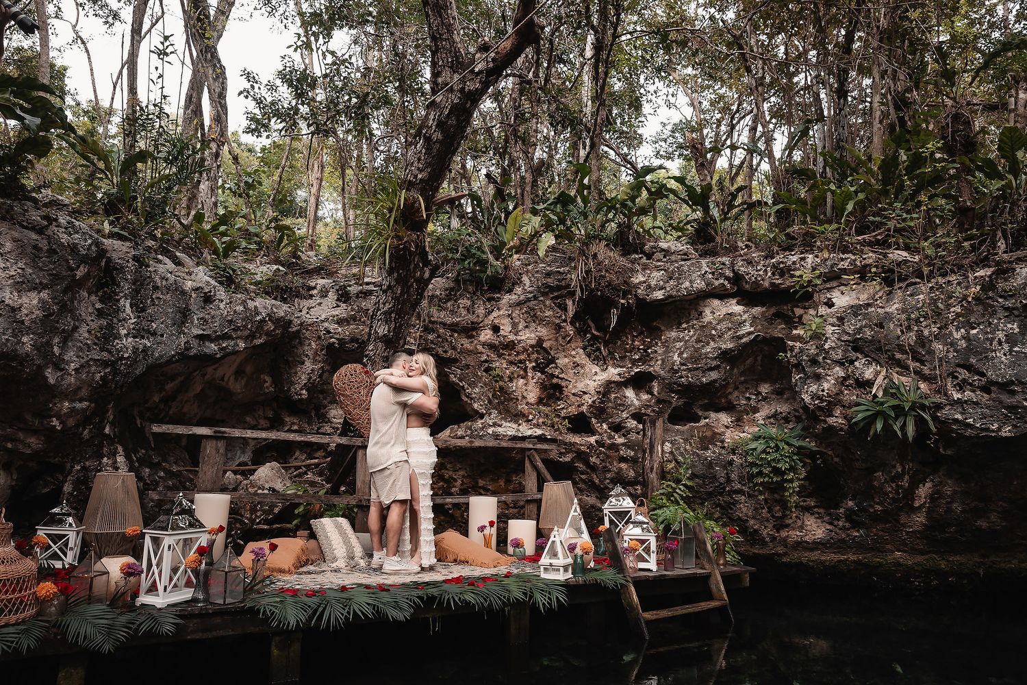 Tropical garden setting with stone walls and decorative elements under natural foliage.