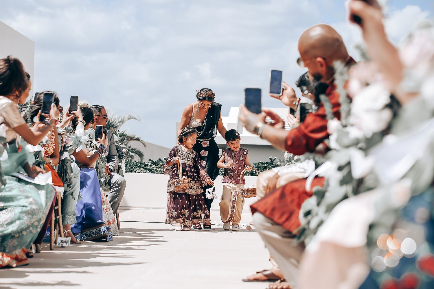 Wedding attendees line up along a pathway to celebrate the special moment.