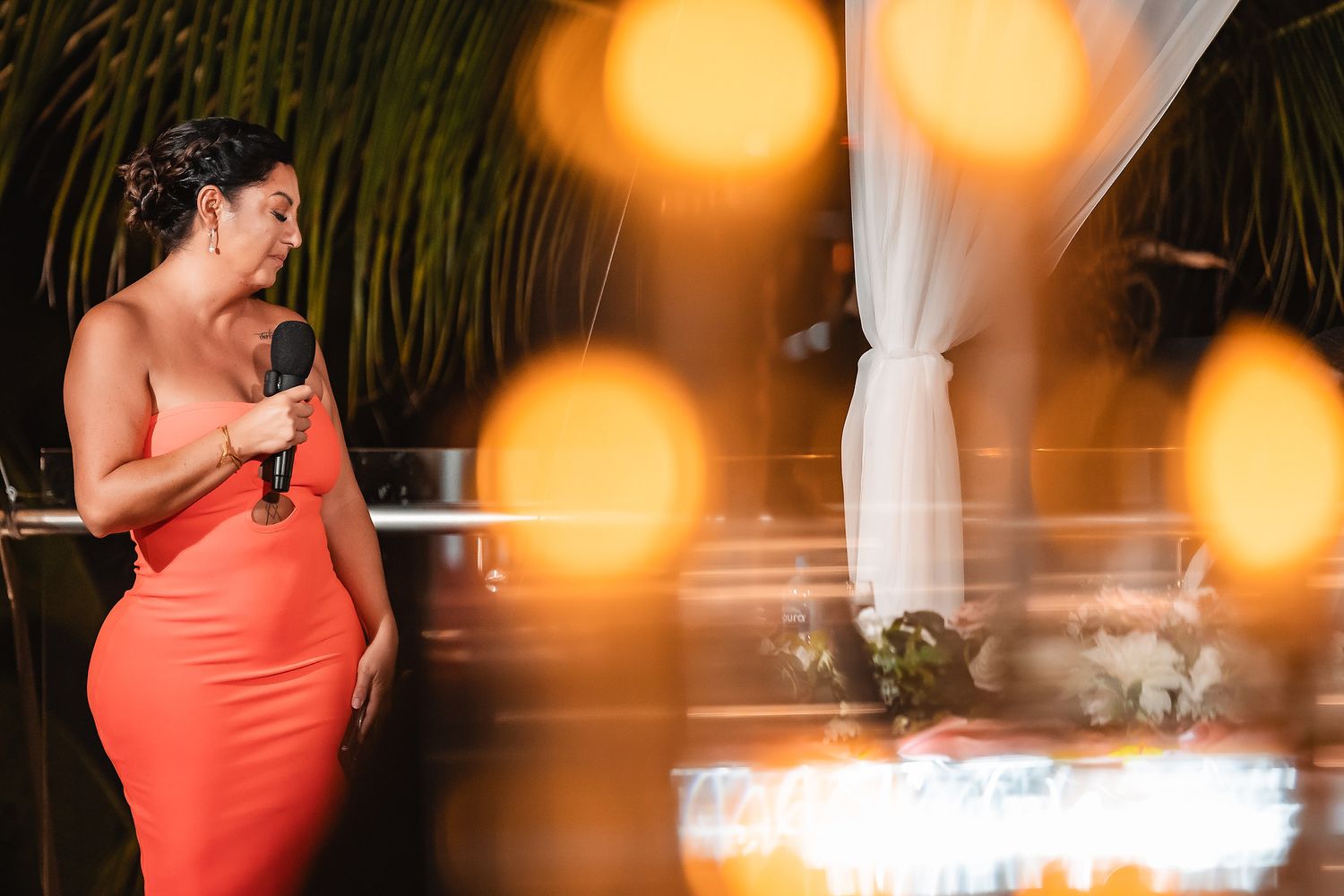 Wedding reception scene with warm glowing bokeh lights creating festive atmosphere.