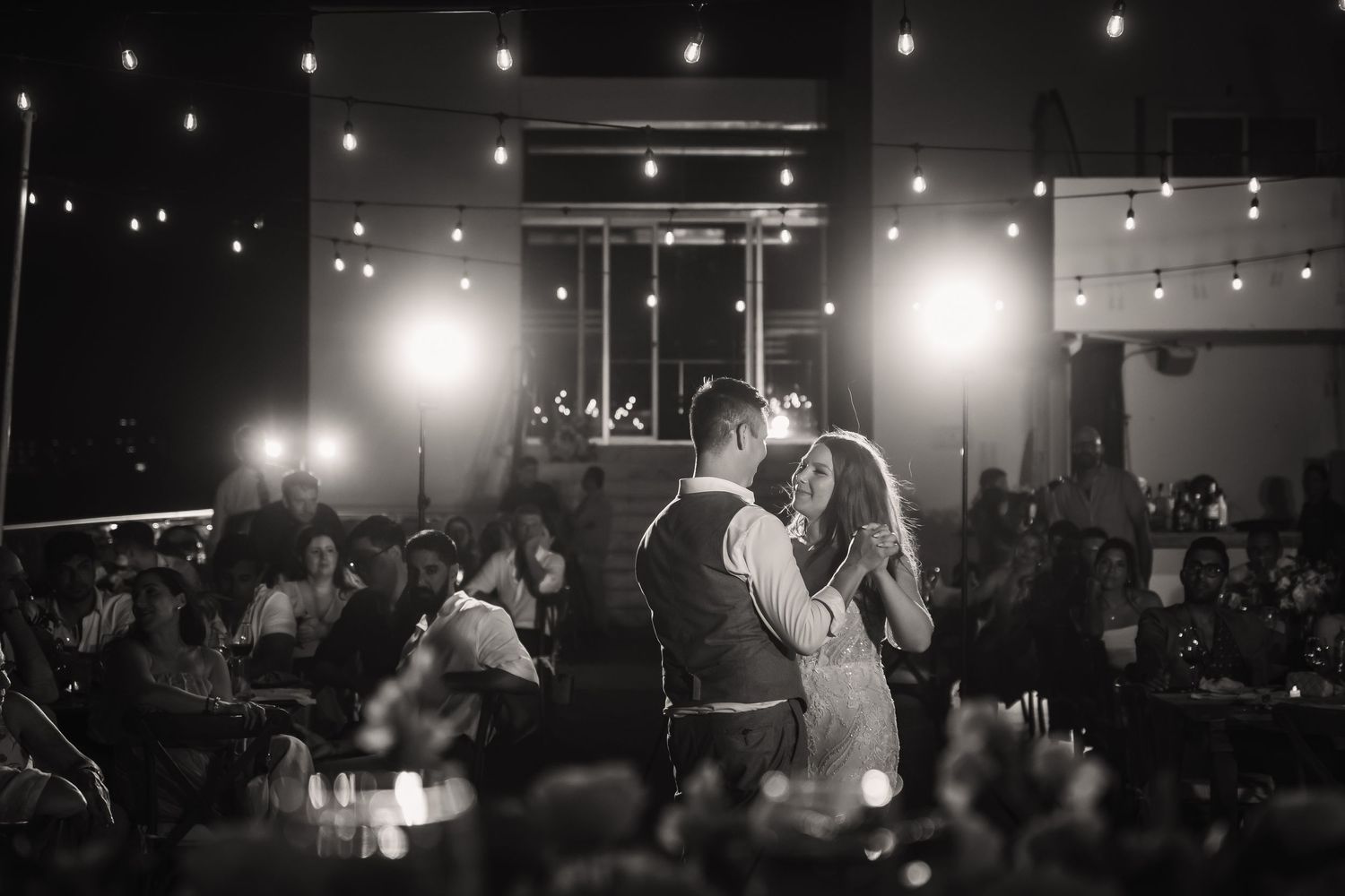 Dimly lit reception venue with string lights creating a romantic atmosphere.