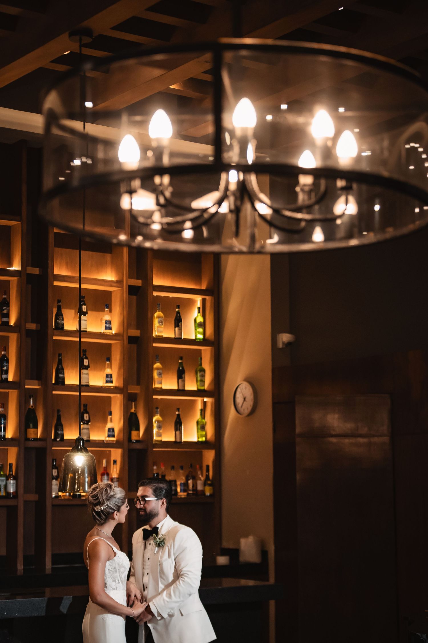Elegant bar interior with backlit bottles and warm ambient lighting creating a luxurious atmosphere.