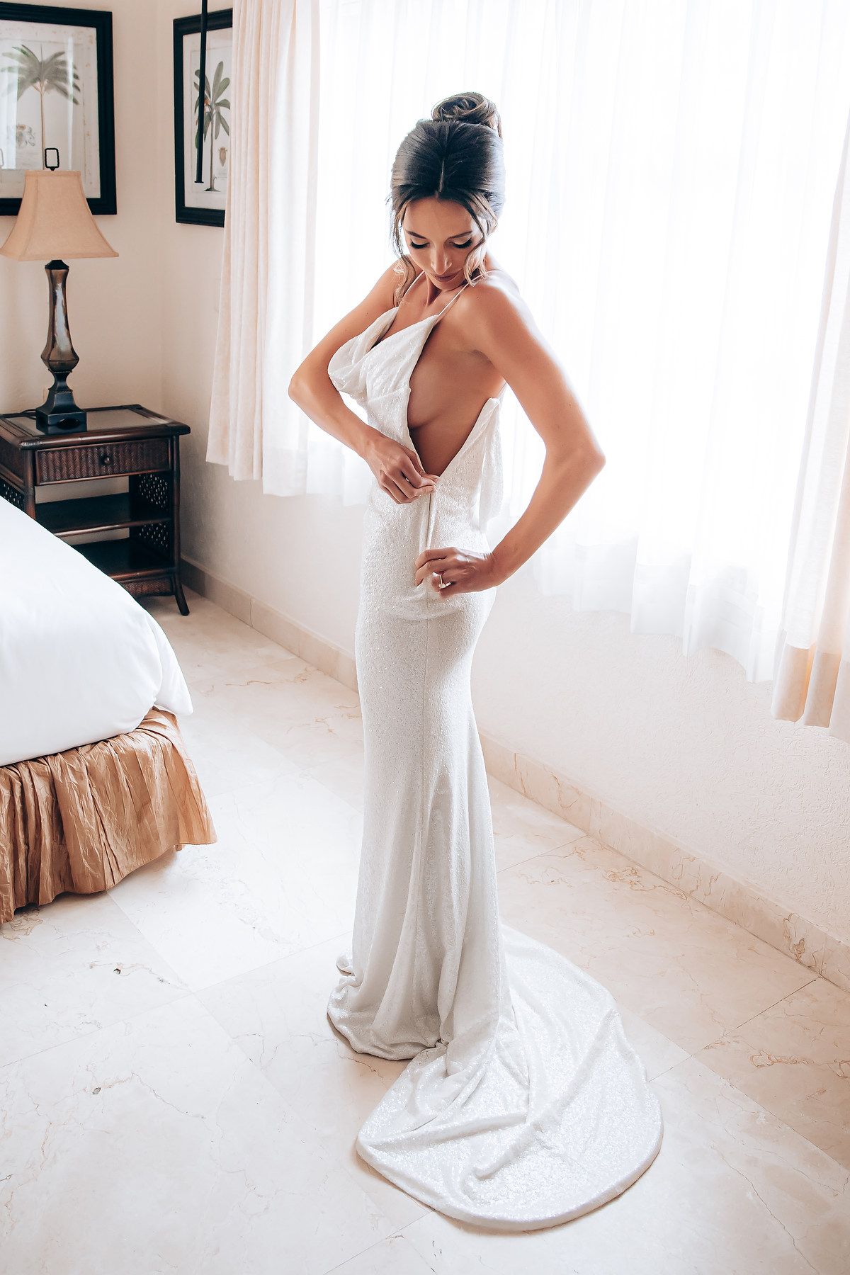 Elegant bridal preparation sequence showing details of white wedding gown.