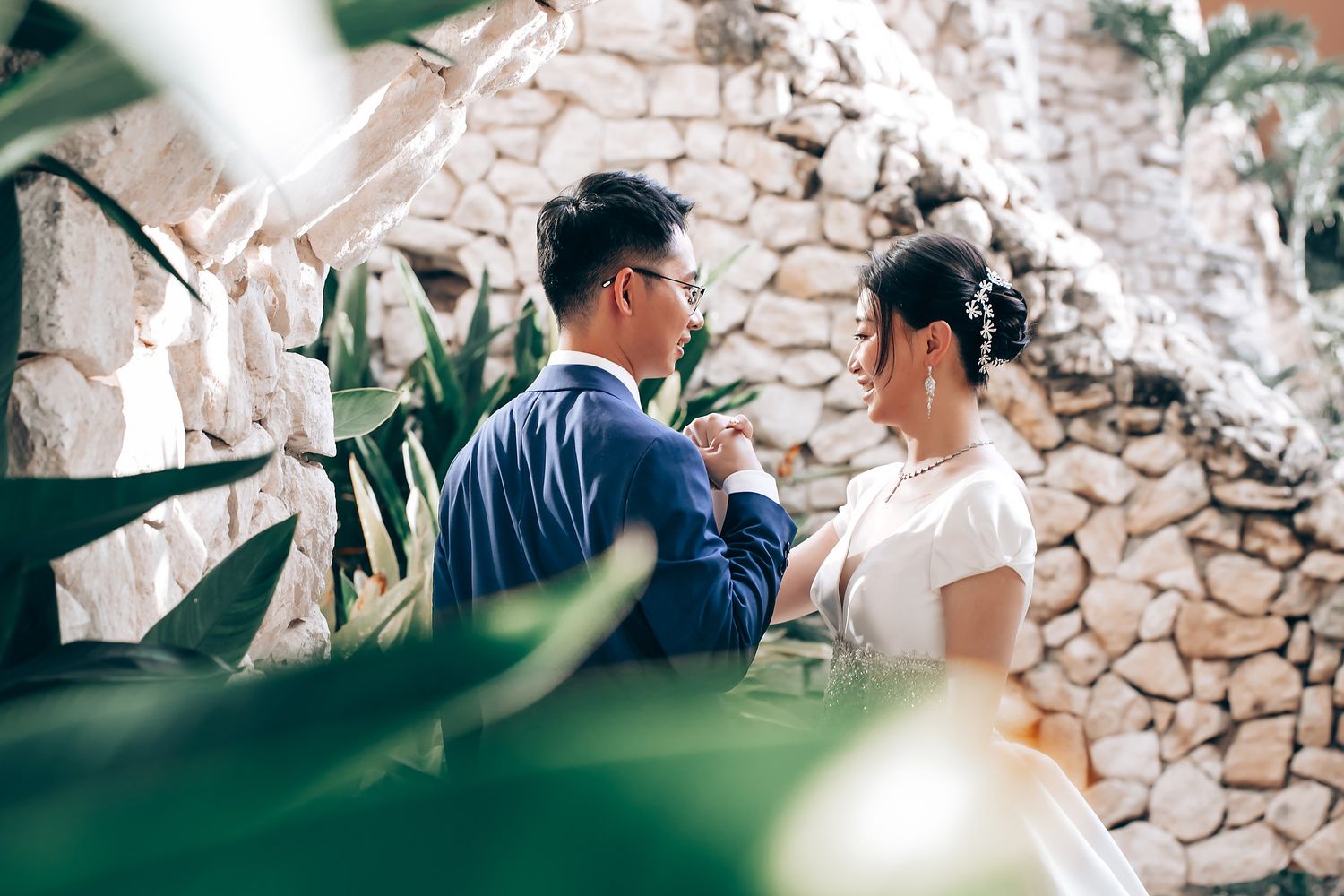 Outdoor wedding ceremony with decorative floral arrangements and natural greenery.