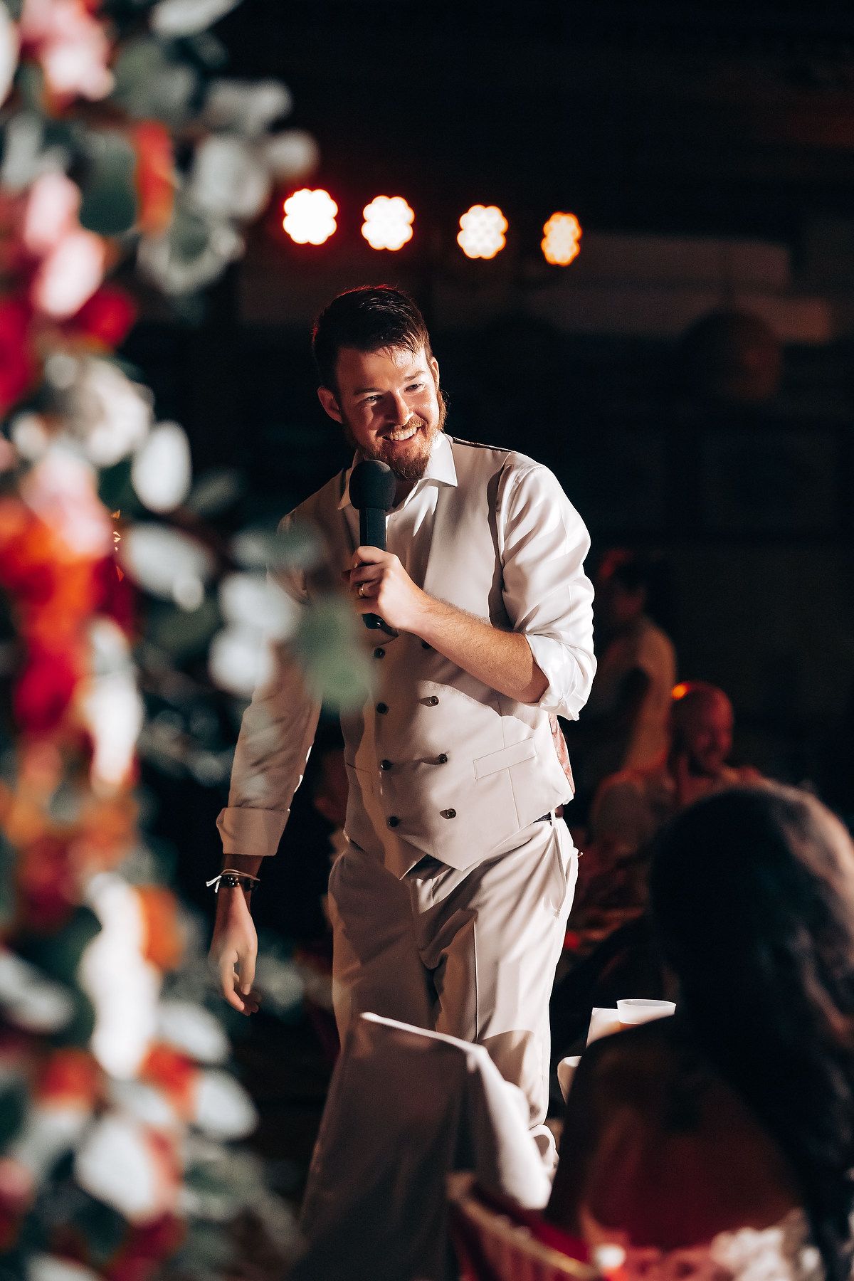 Wedding reception dance captured in dramatic lighting with festive decorations.