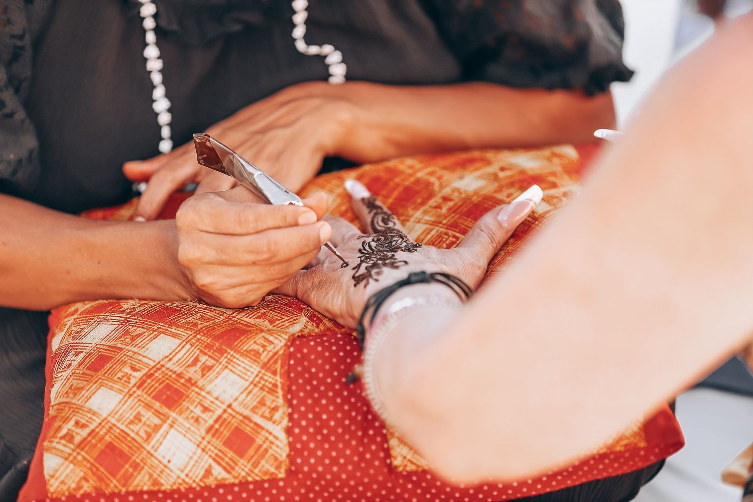 Hands using a sewing machine to stitch red and white plaid fabric together in a series of detailed steps.