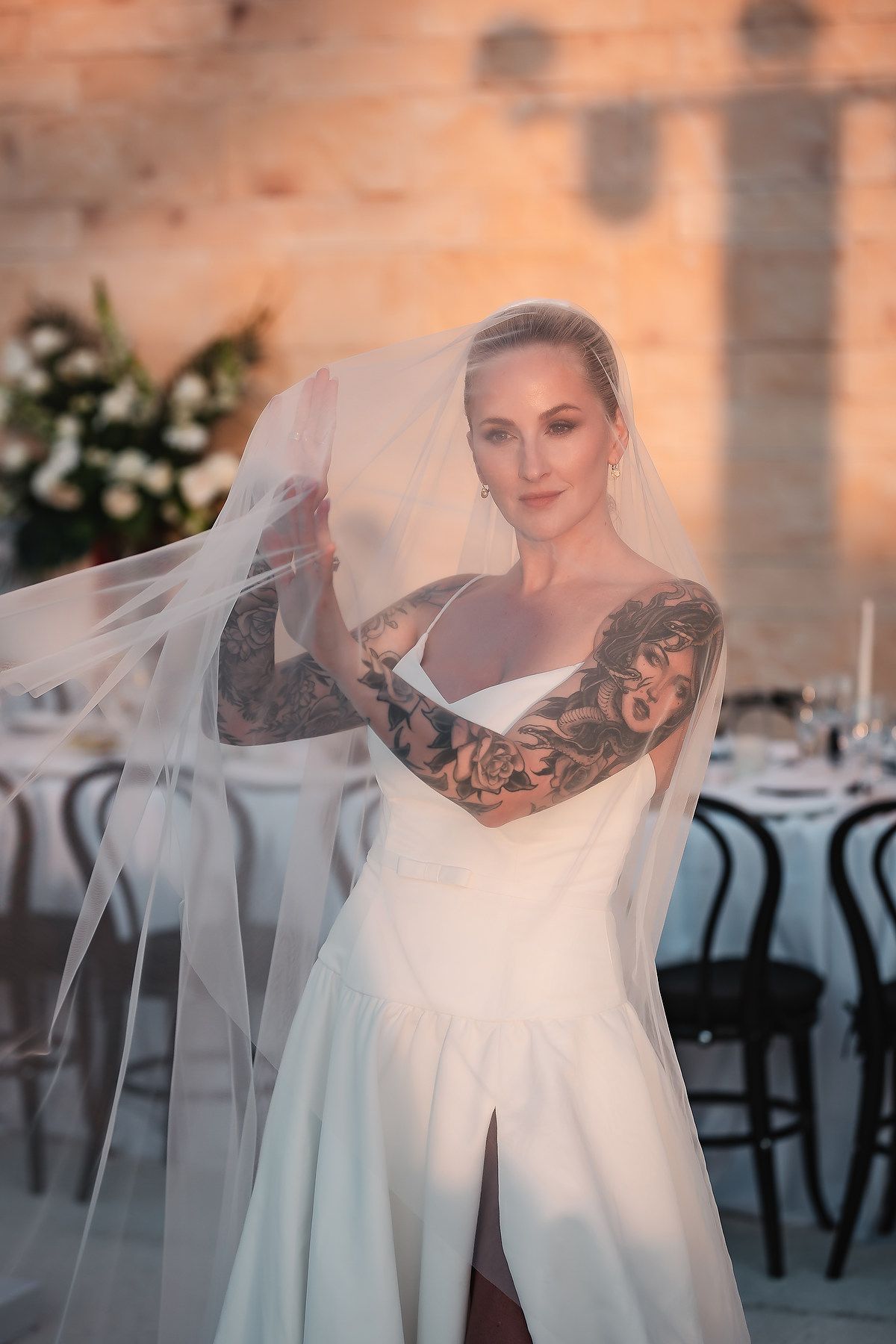 Artistic bridal portraits with flowing veil creating ethereal effects in natural light.