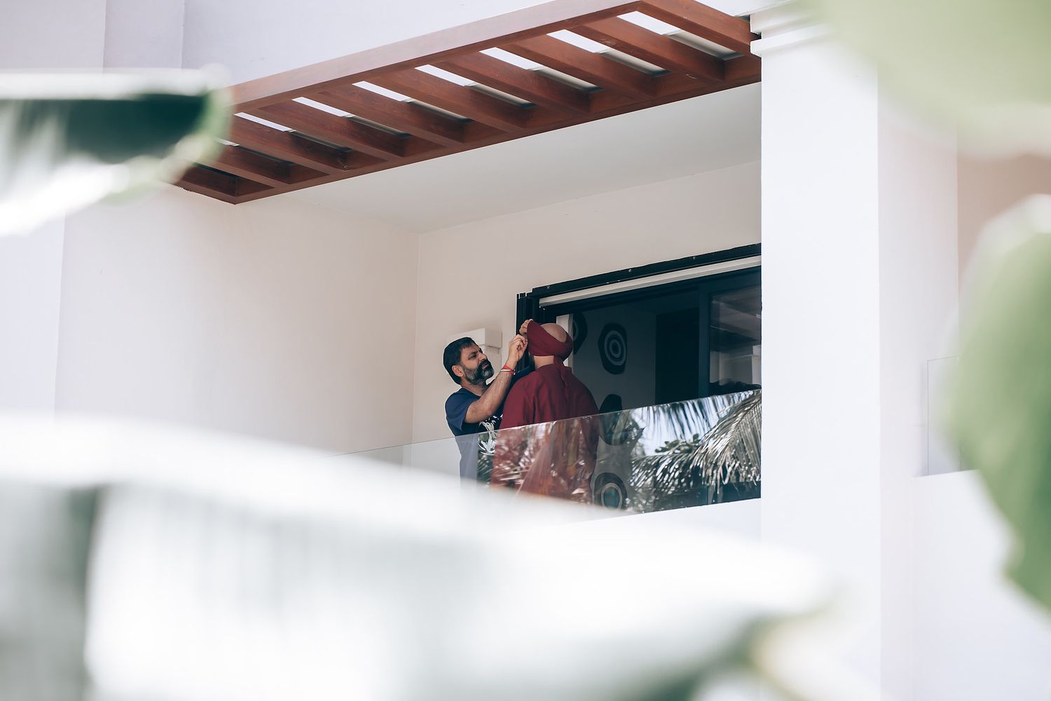 Modern architectural details of a tropical wedding venue with wooden pergola.