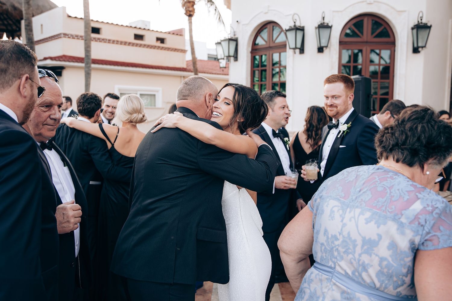 Wedding guests dance and celebrate together during a joyful reception on the dance floor.