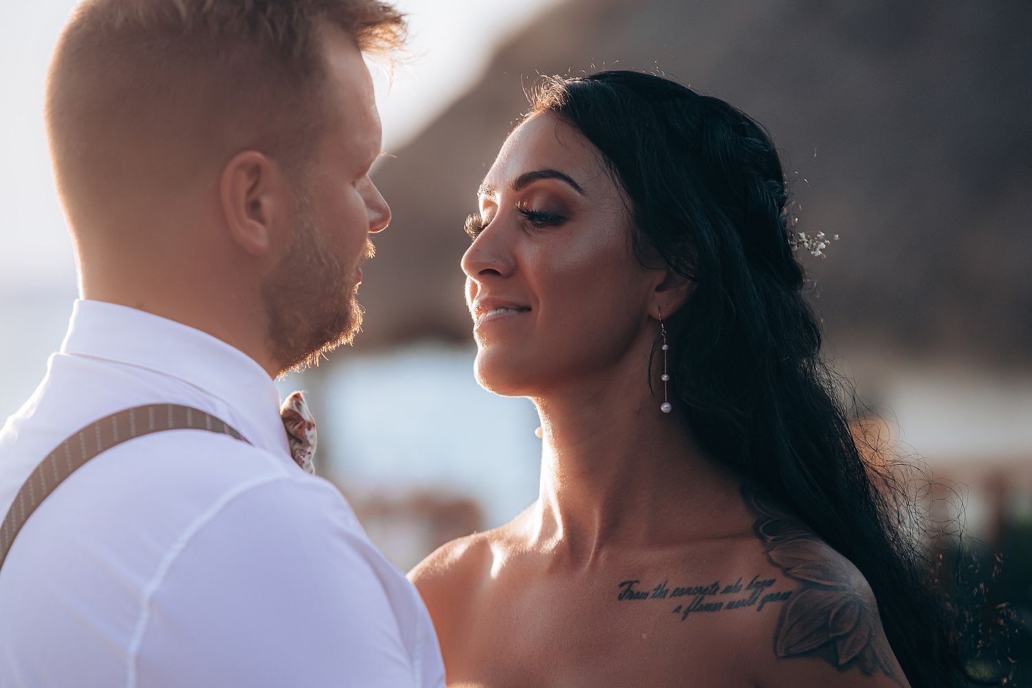 Intimate wedding portrait session at sunset with soft lighting.