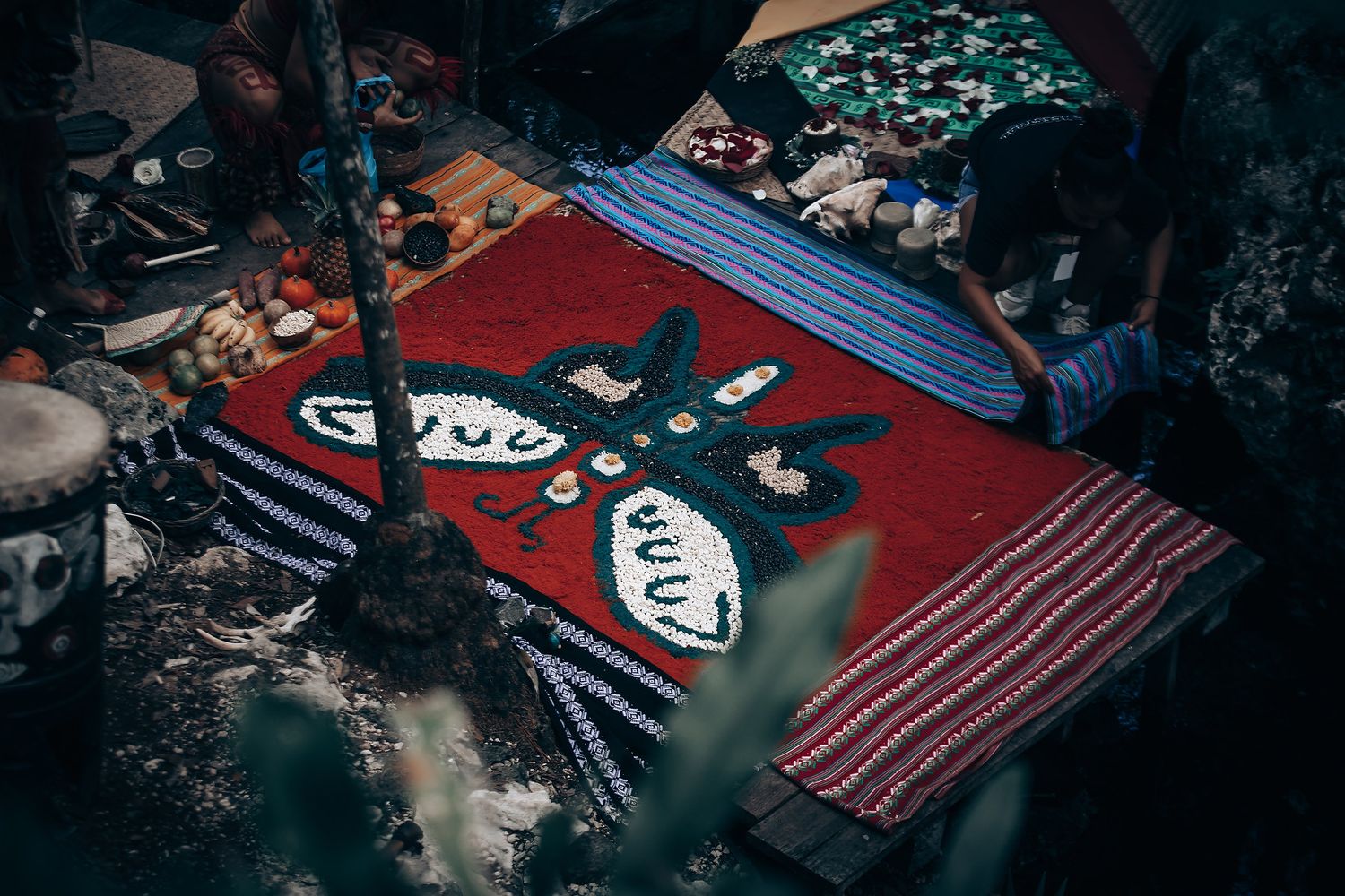 Artistic close-up photograph of playing cards and poker chips scattered on a dark surface with dramatic lighting.