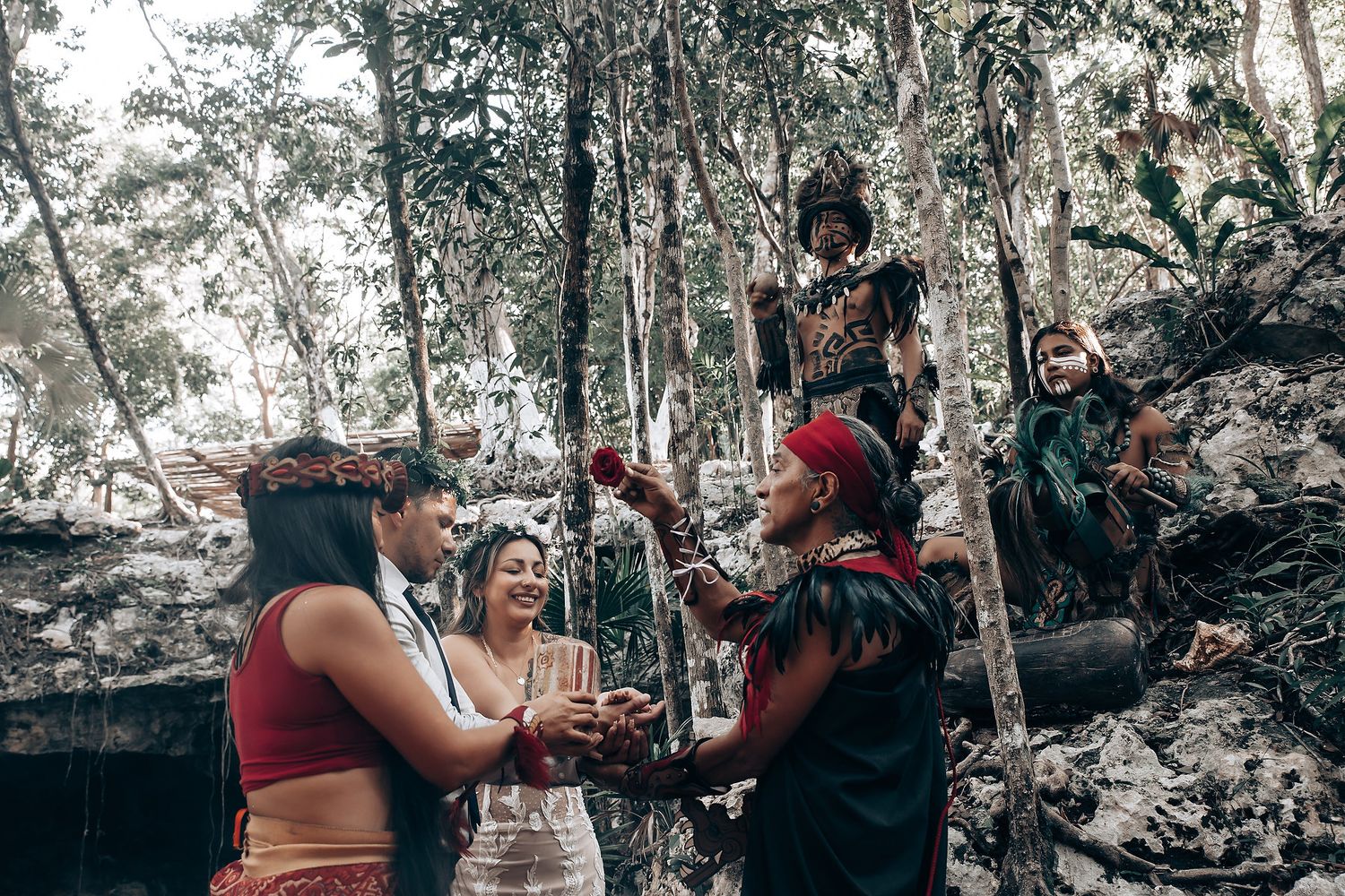 A moody wedding photoshoot in a wooded area with dramatic lighting and smoke effects.