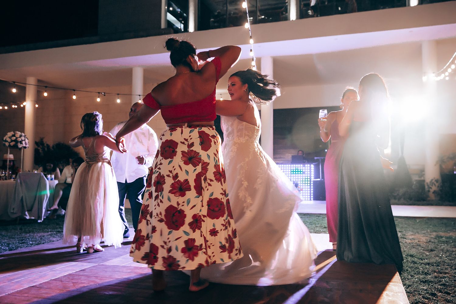 Wedding reception dance floor with string lights creating romantic ambiance.