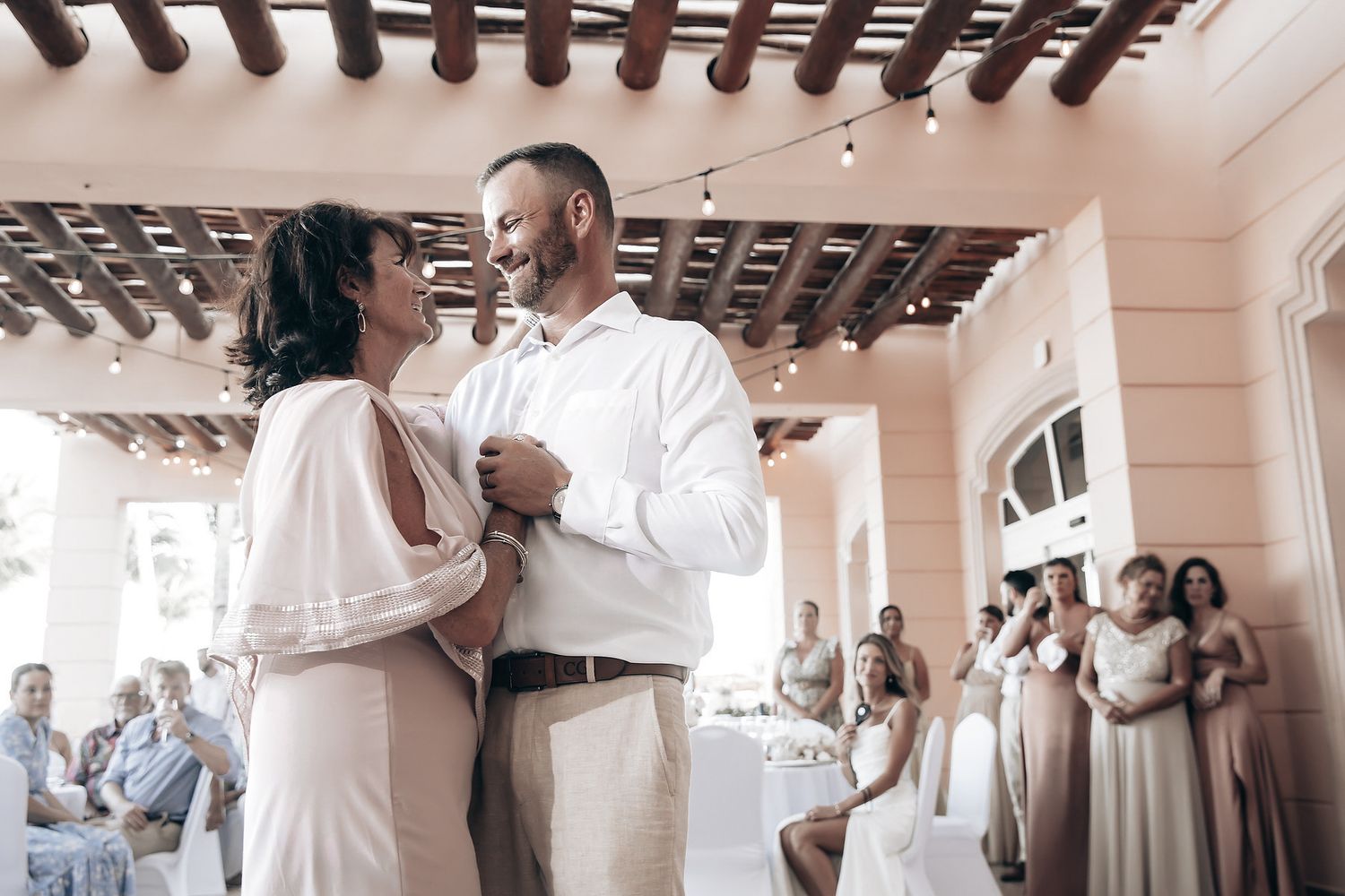A wedding couple dancing together at their reception.
