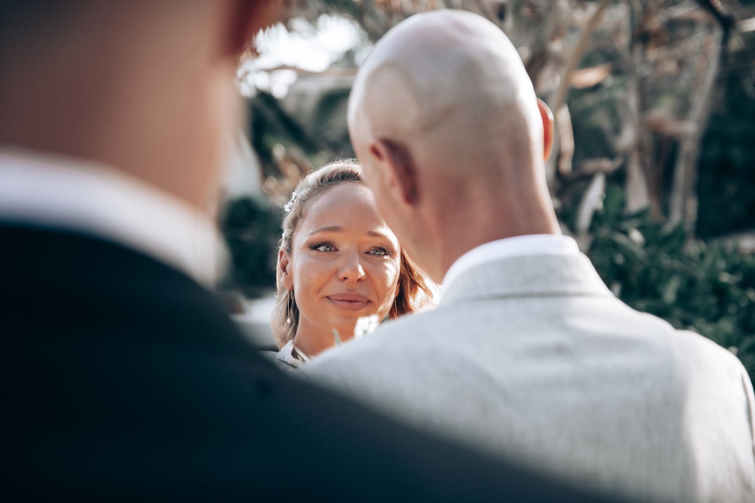 Intimate wedding ceremony moment on a sunny beach.