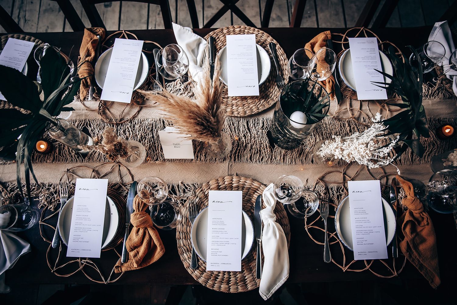 Overhead view of beautifully decorated wedding reception tables with rustic place settings.