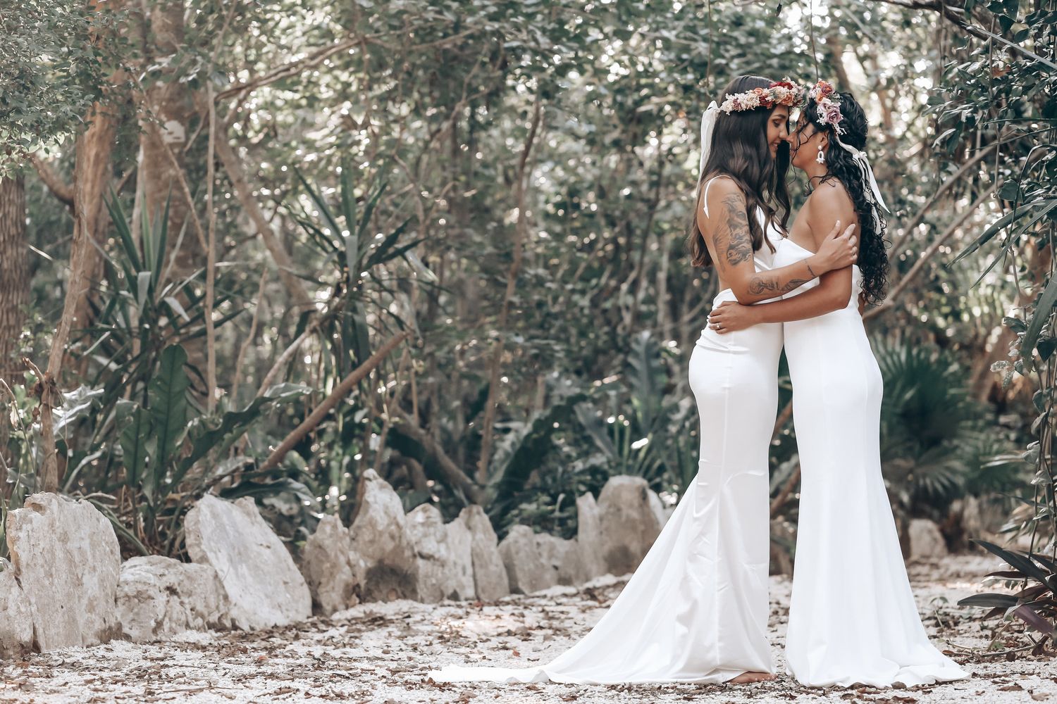 A romantic wedding photoshoot in a natural forest setting with limestone formations.