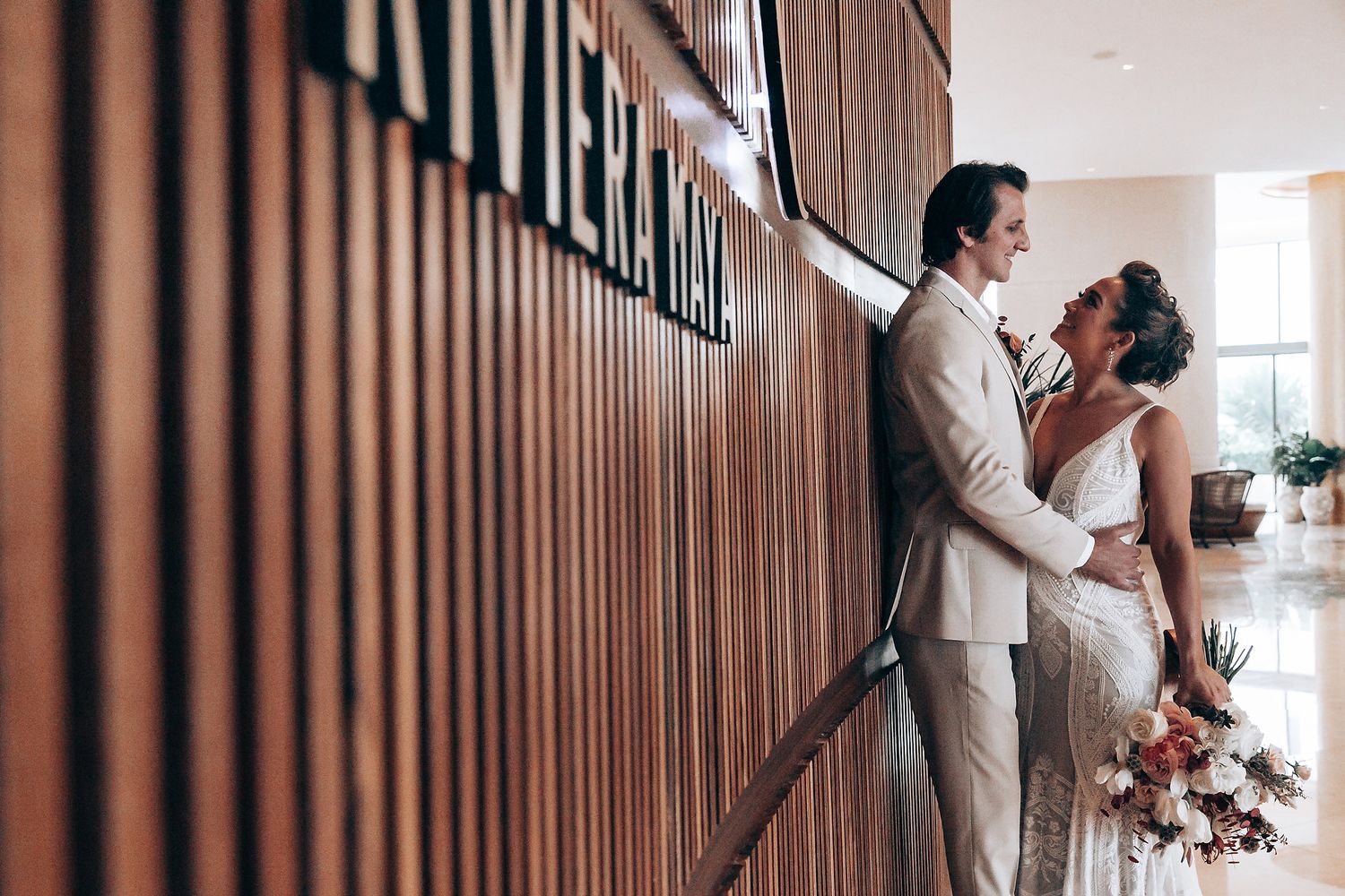 Modern wedding venue interior with wooden panel walls and natural lighting.