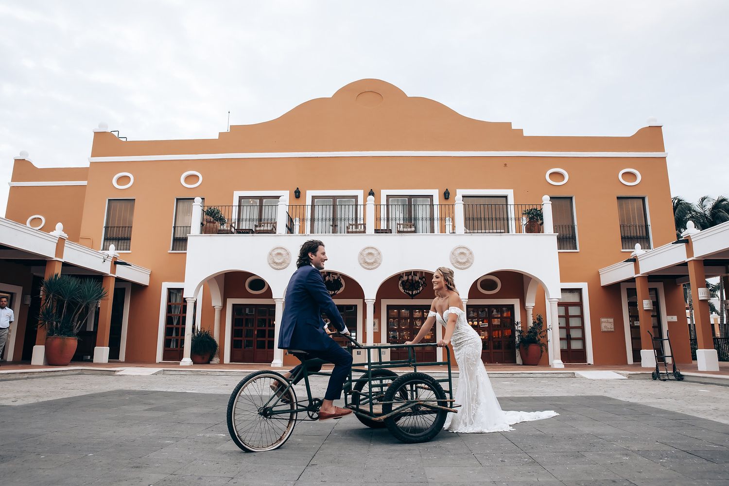 Spanish colonial style wedding venue with terracotta walls and arched doorways.