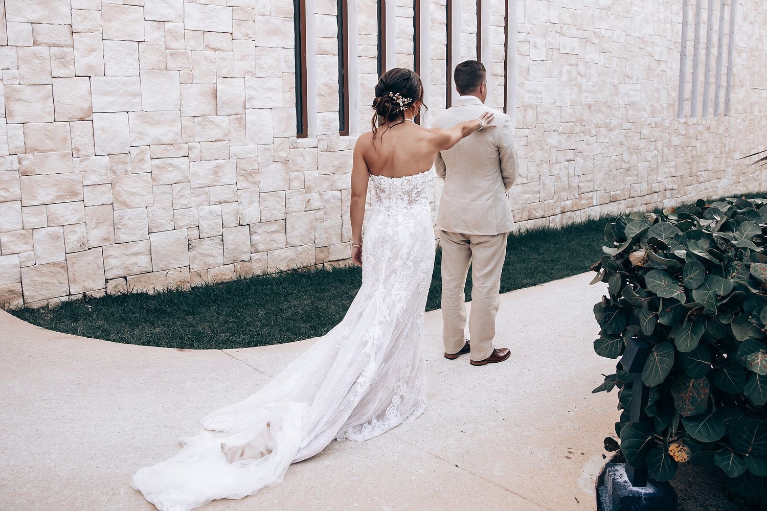A wedding ceremony setup with white stone walls and elegant decor details.