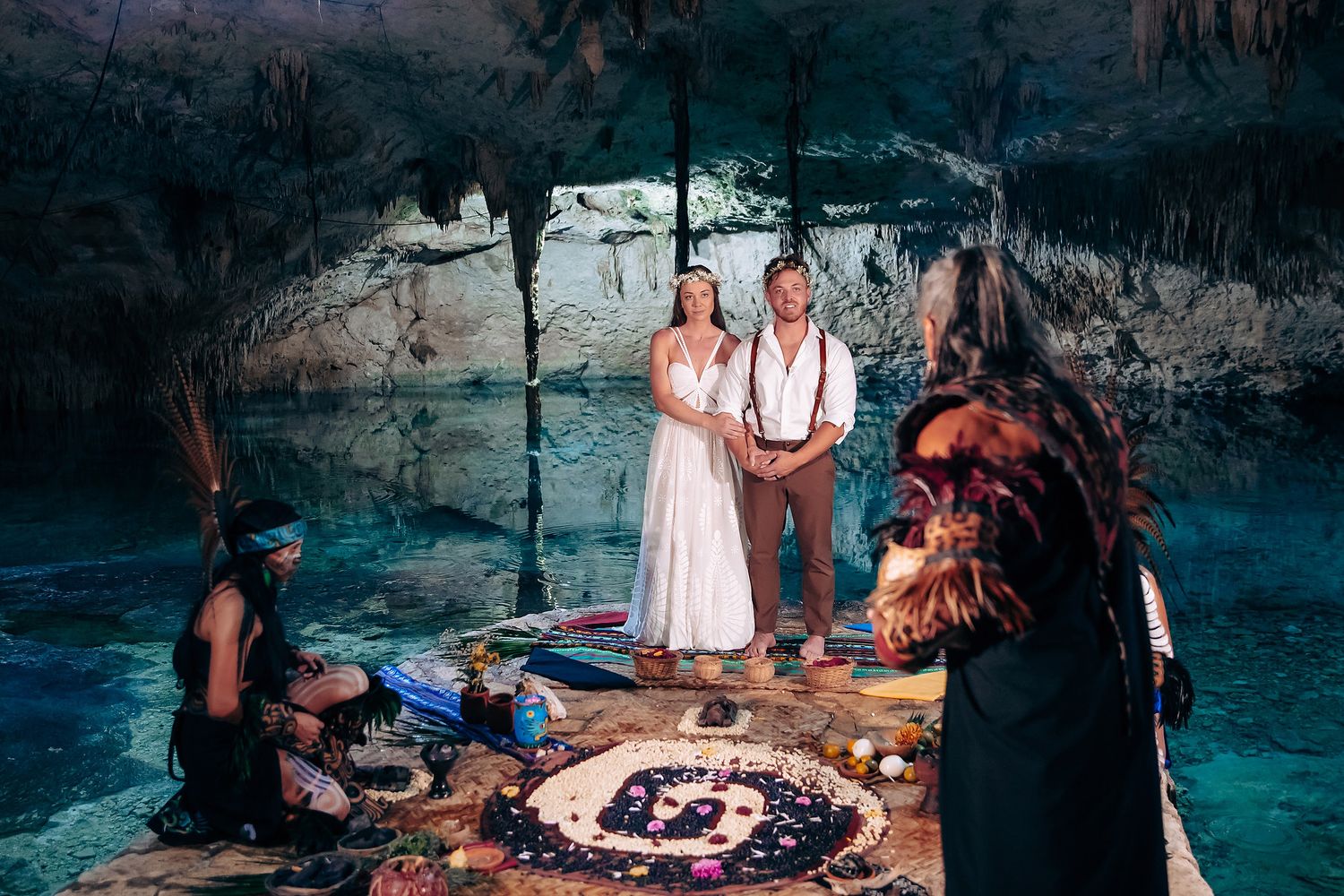 Traditional Mayan ceremony performed in a sacred cave with natural light streaming through the cavern opening.
