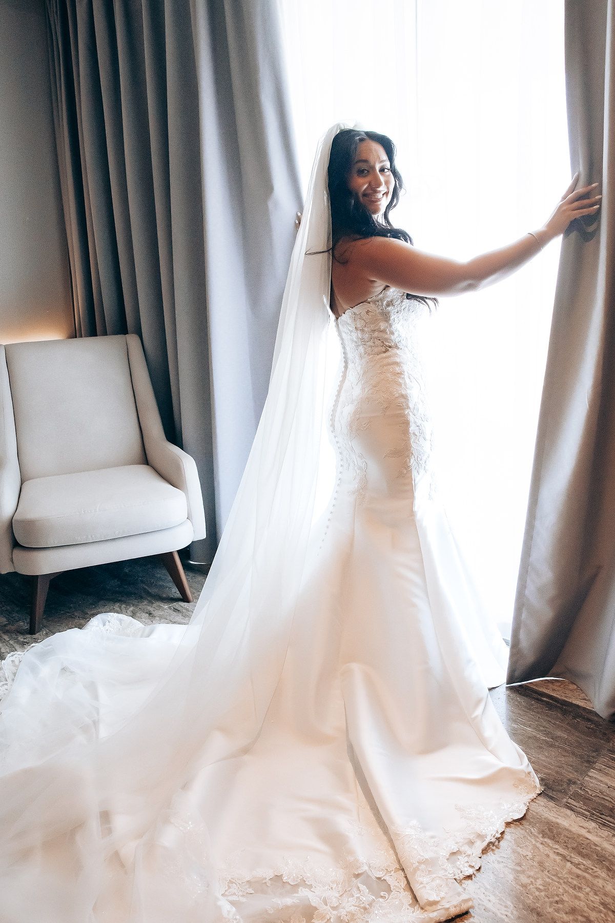 A series of photos showing a bride in a white wedding dress twirling and posing by curtained windows.