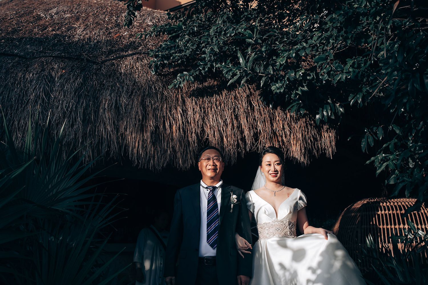 Wedding photography in a tropical garden setting with natural foliage.